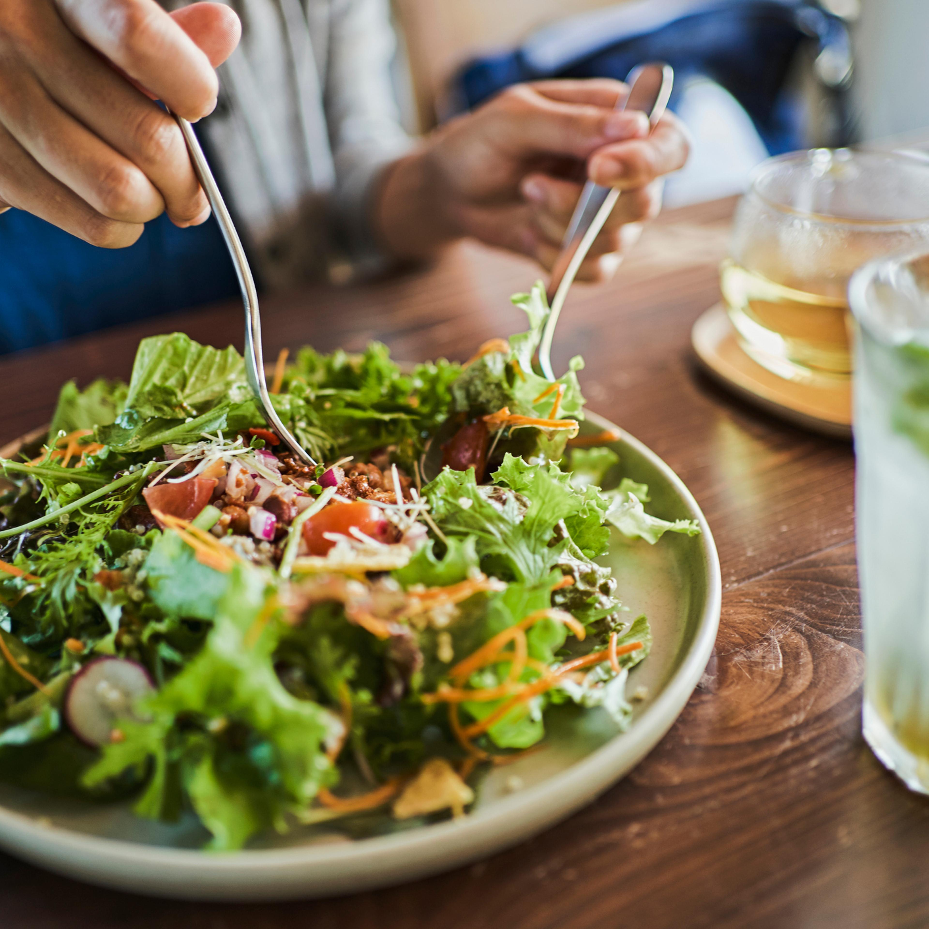 Japanese woman eating a vegan lunch at a vegan cafe