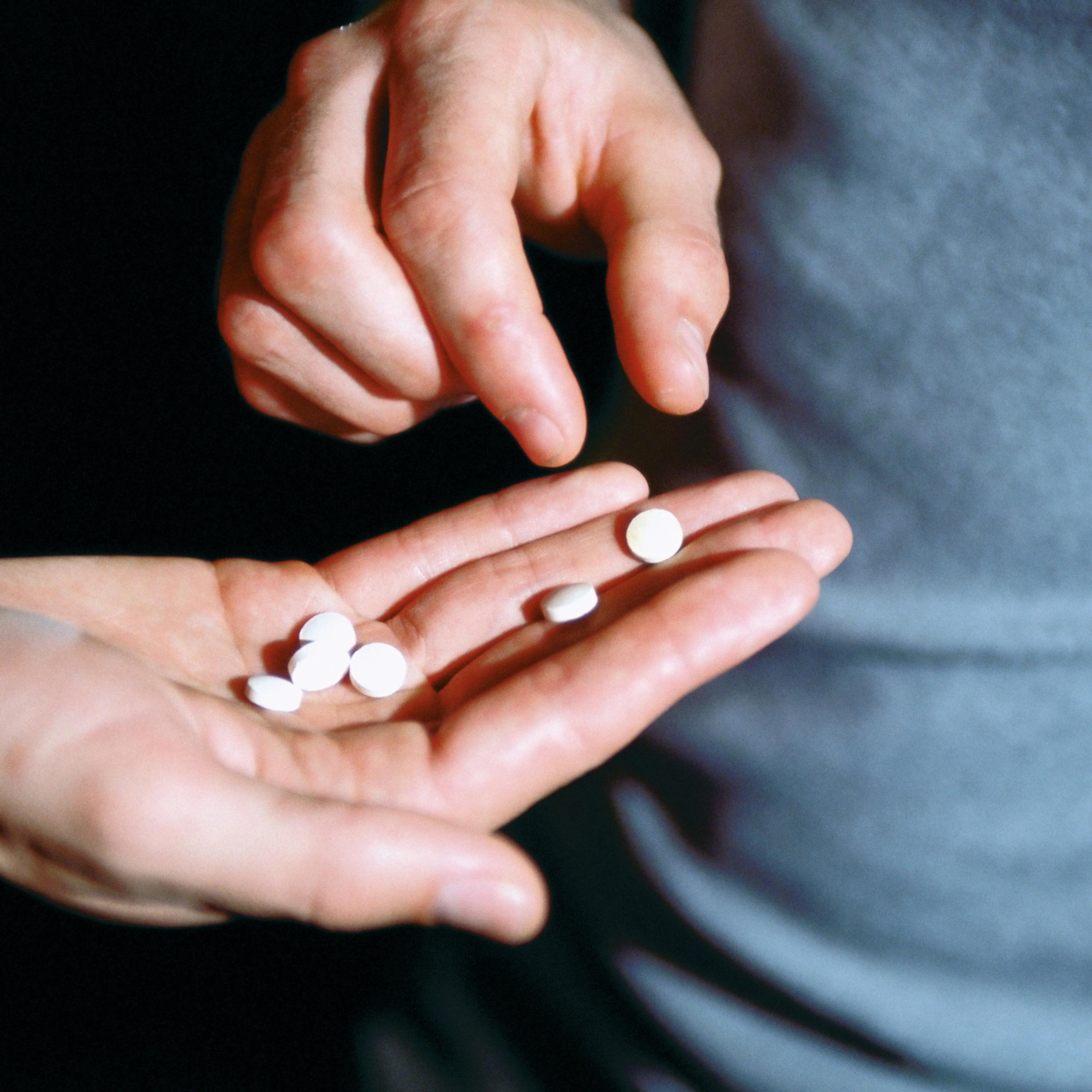 Male hand holding recreational drugs