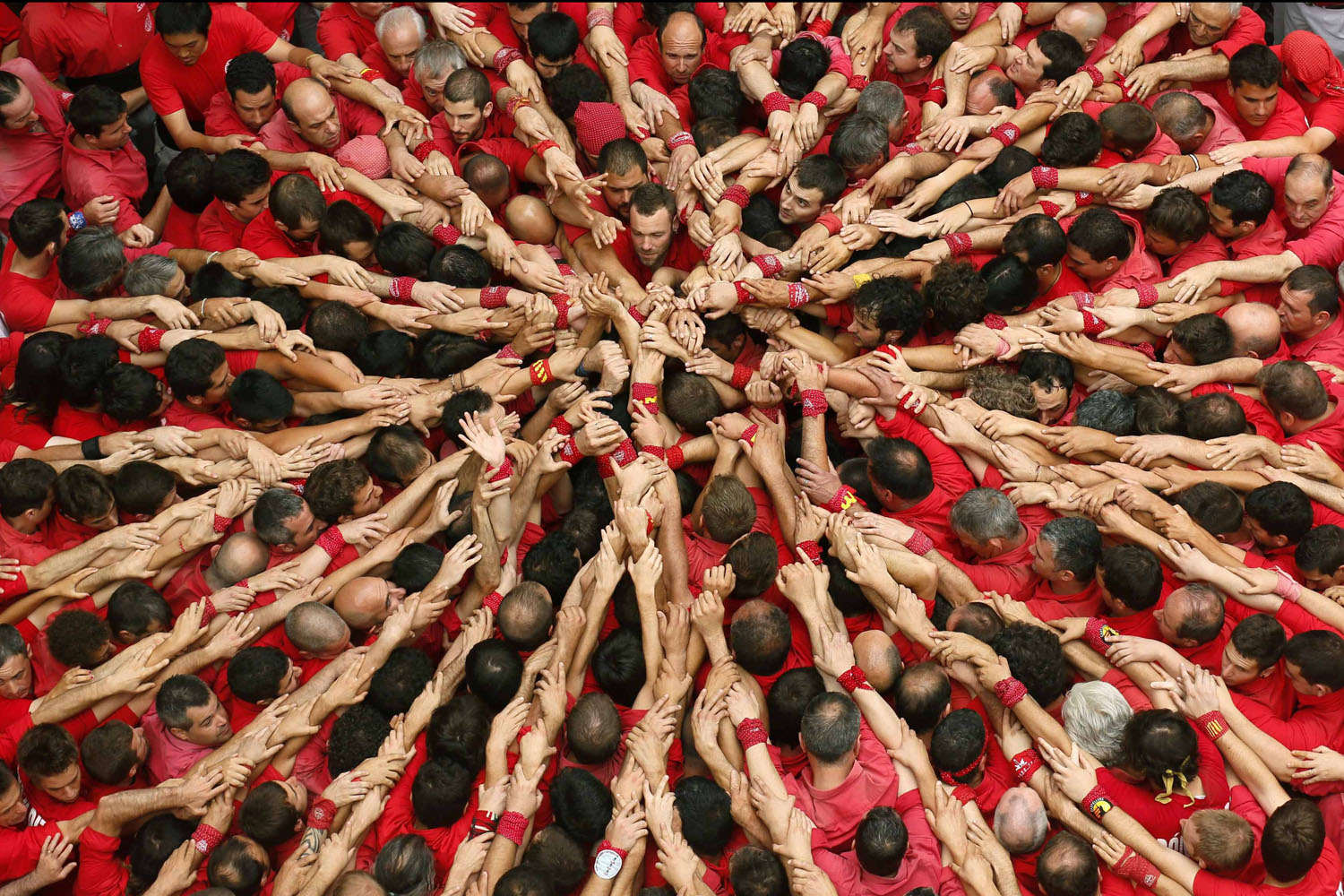 Castellers Colla Joves Xiquets de Valls start to form a human tower called "castells" during the Sant Joan festival at Plaza del Blat square in Valls