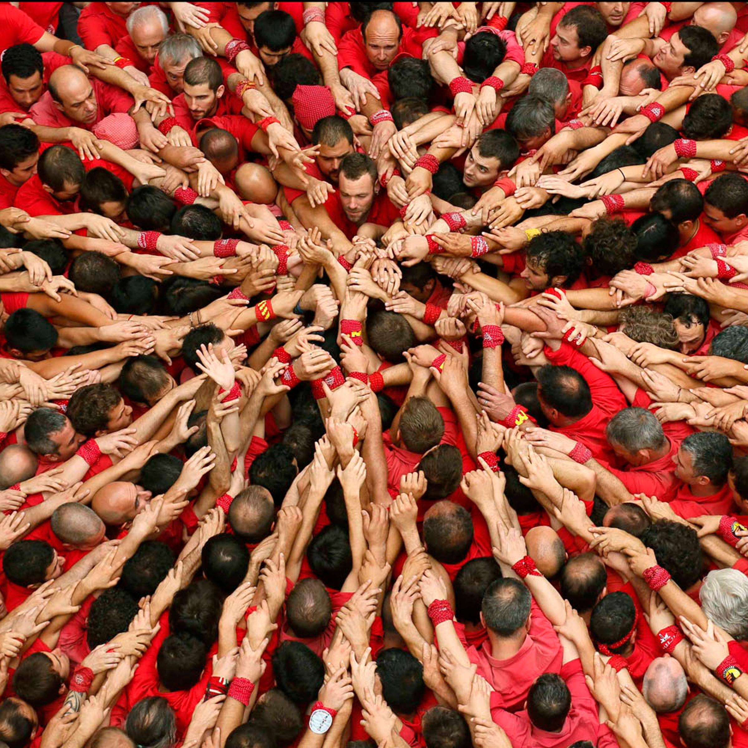 Castellers Colla Joves Xiquets de Valls start to form a human tower called "castells" during the Sant Joan festival at Plaza del Blat square in Valls