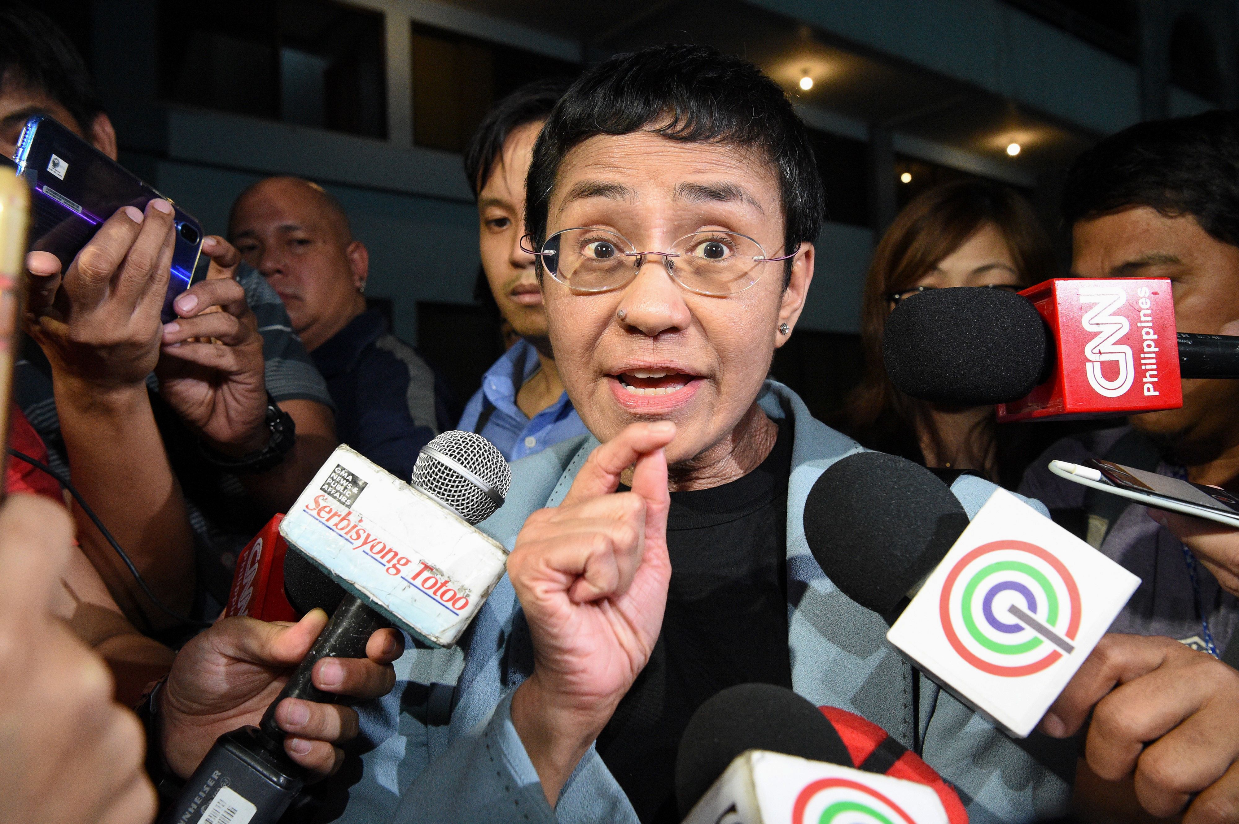Journalist Maria Ressa speaks to the media as she arrives at the National Bureau of Investigation headquarters