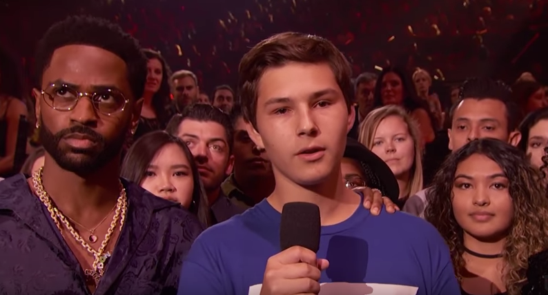 Alex Moscou, a survivor of the school shooting in Parkland, Florida, on Feb. 14, speaks during the iHeartRadio Music Awards! on March 11.