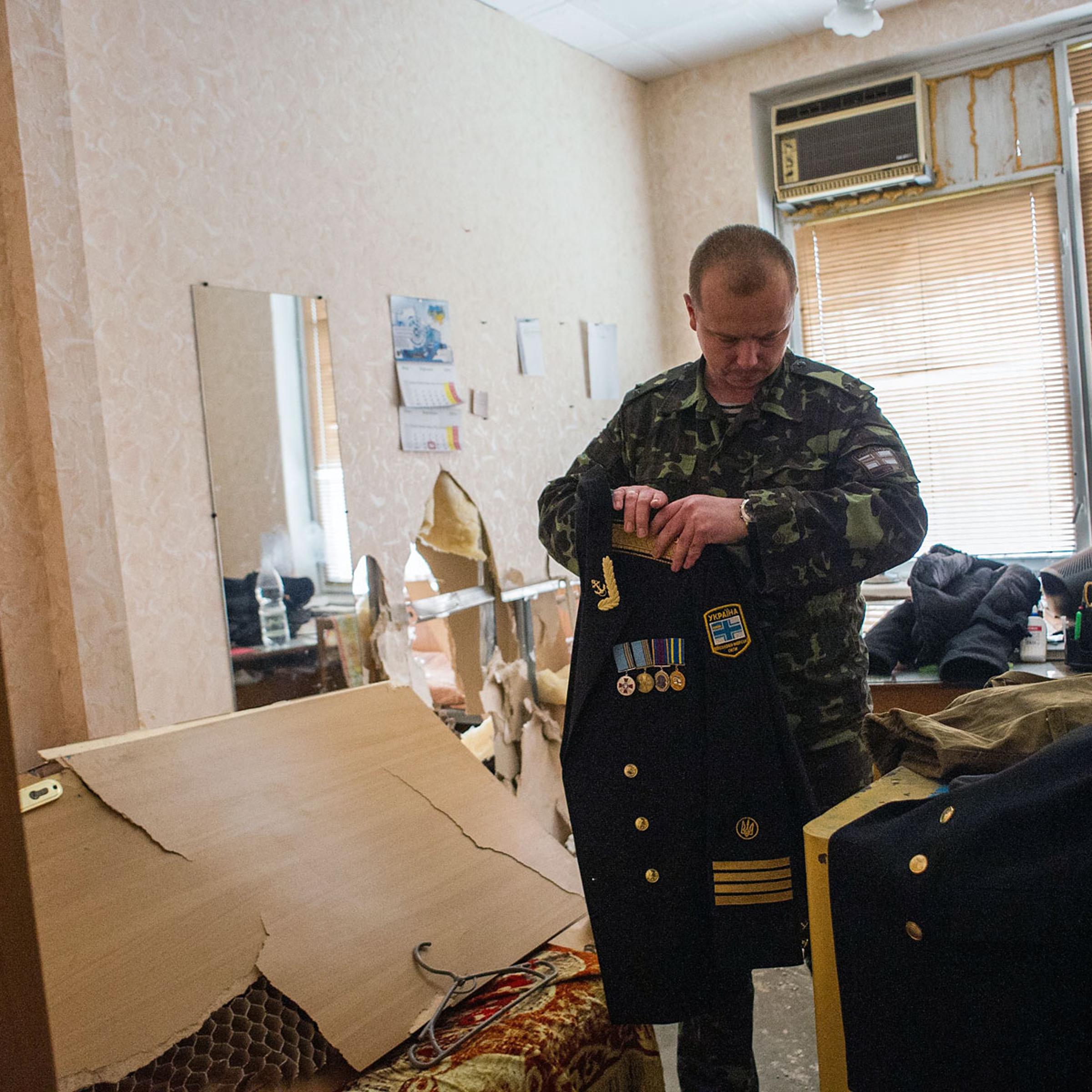 A Ukrainian serviceman packs his things in the Ukrainian navy headquarters after it was stormed by Crimean pro-Russian self-defense forces in Sevastopol, Crimea