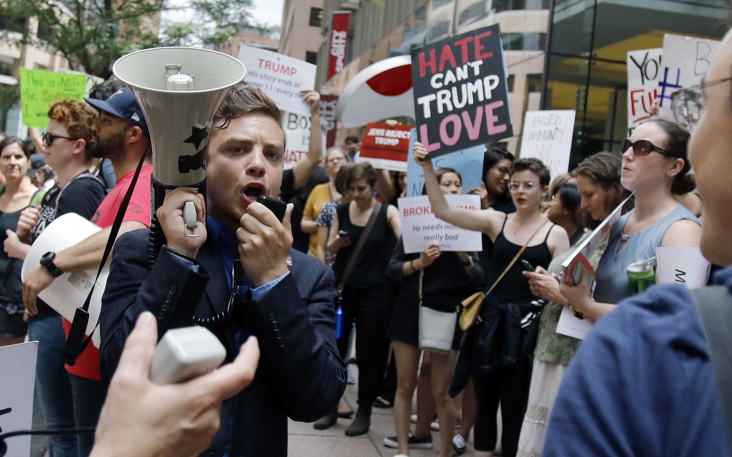 Protestors chant outside a downtown hotel where Donald Trump was holding a lunchtime fundraiser in Boston, June 29, 2016.