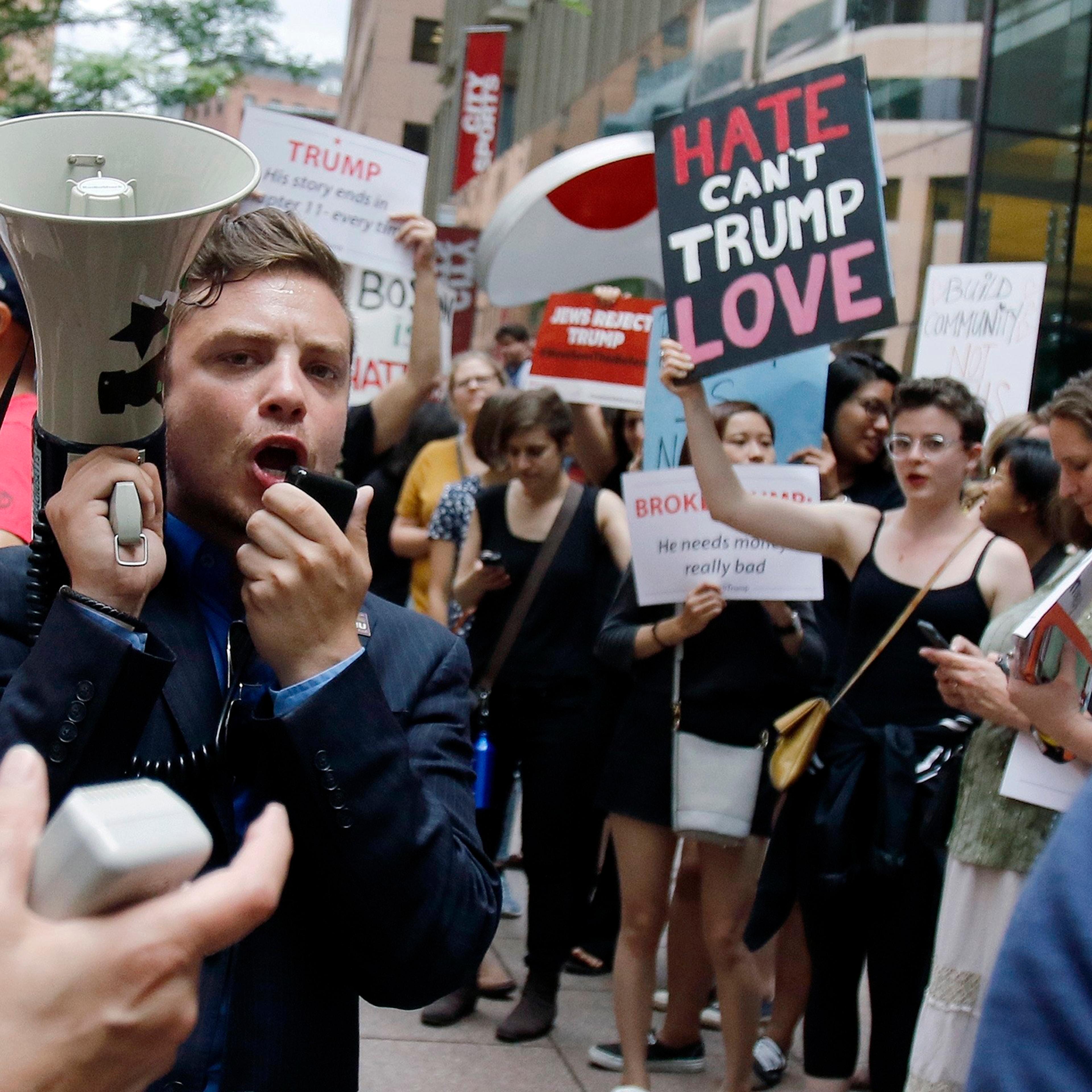 Protestors chant outside a downtown hotel where Donald Trump was holding a lunchtime fundraiser in Boston, June 29, 2016.
