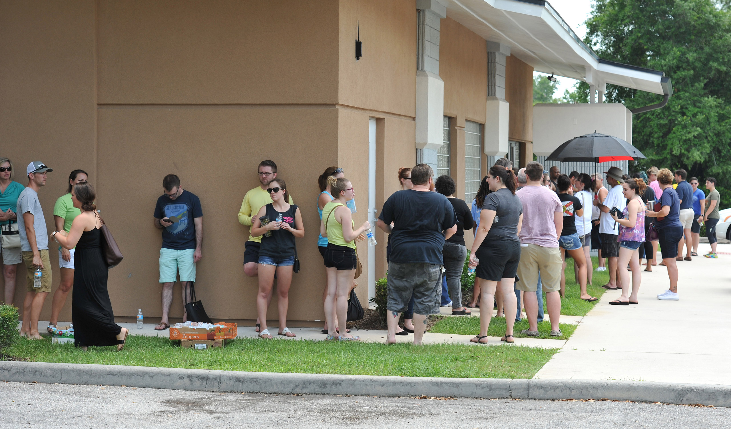 Potential blood donors line up outside the oneblood facility on Beach Blvd. In Jacksonville, Fla., Sunday, June 12, 2016, to help the victims from the shooting at a nightclub in Orlando. A gunman wielding an assault-type rifle and a handgun opened fire i