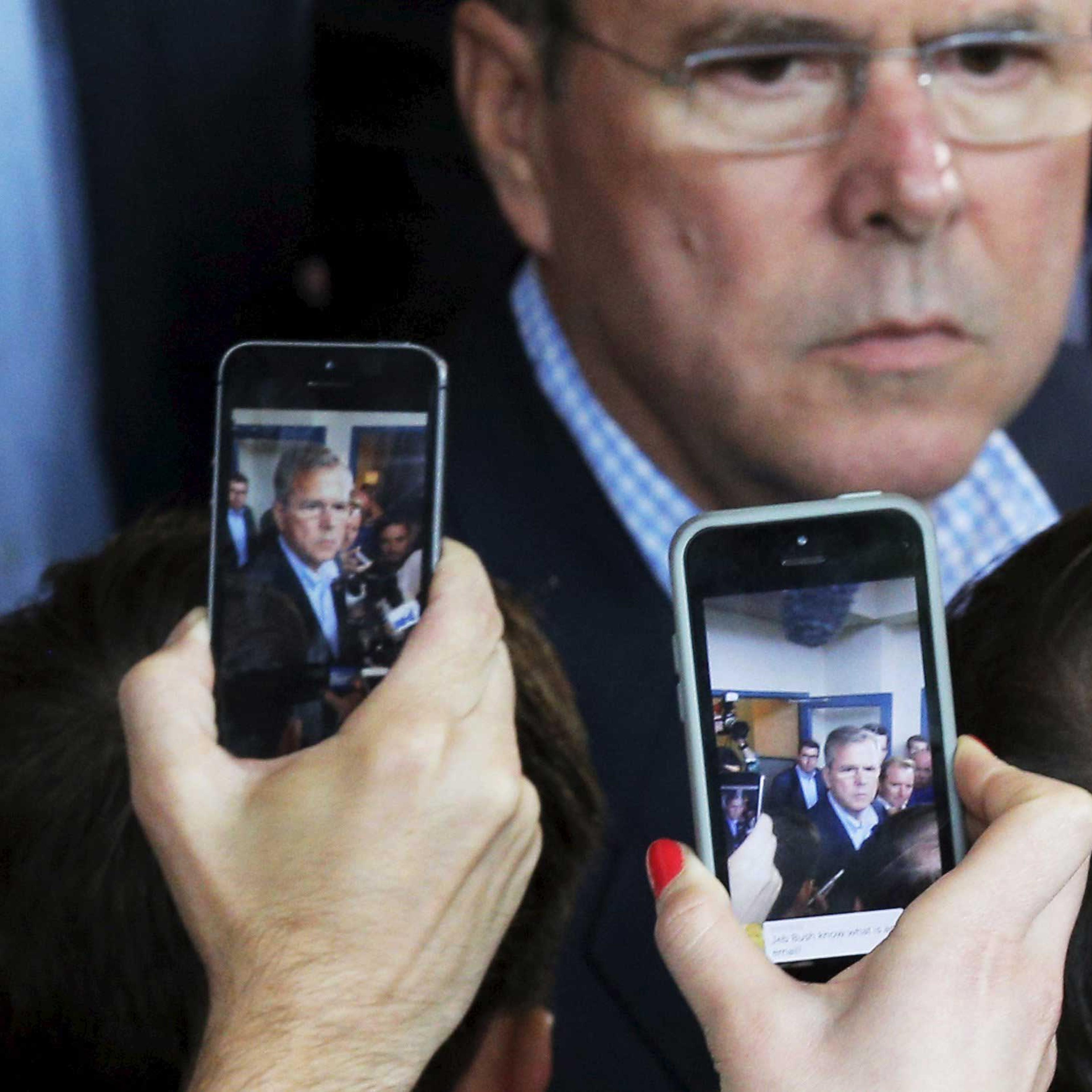 Reporters use their mobile phones to record potential 2016 Republican presidential candidate Jeb Bush as he answers questions after a business roundtable in Portsmouth, N.H. on May 20, 2015.