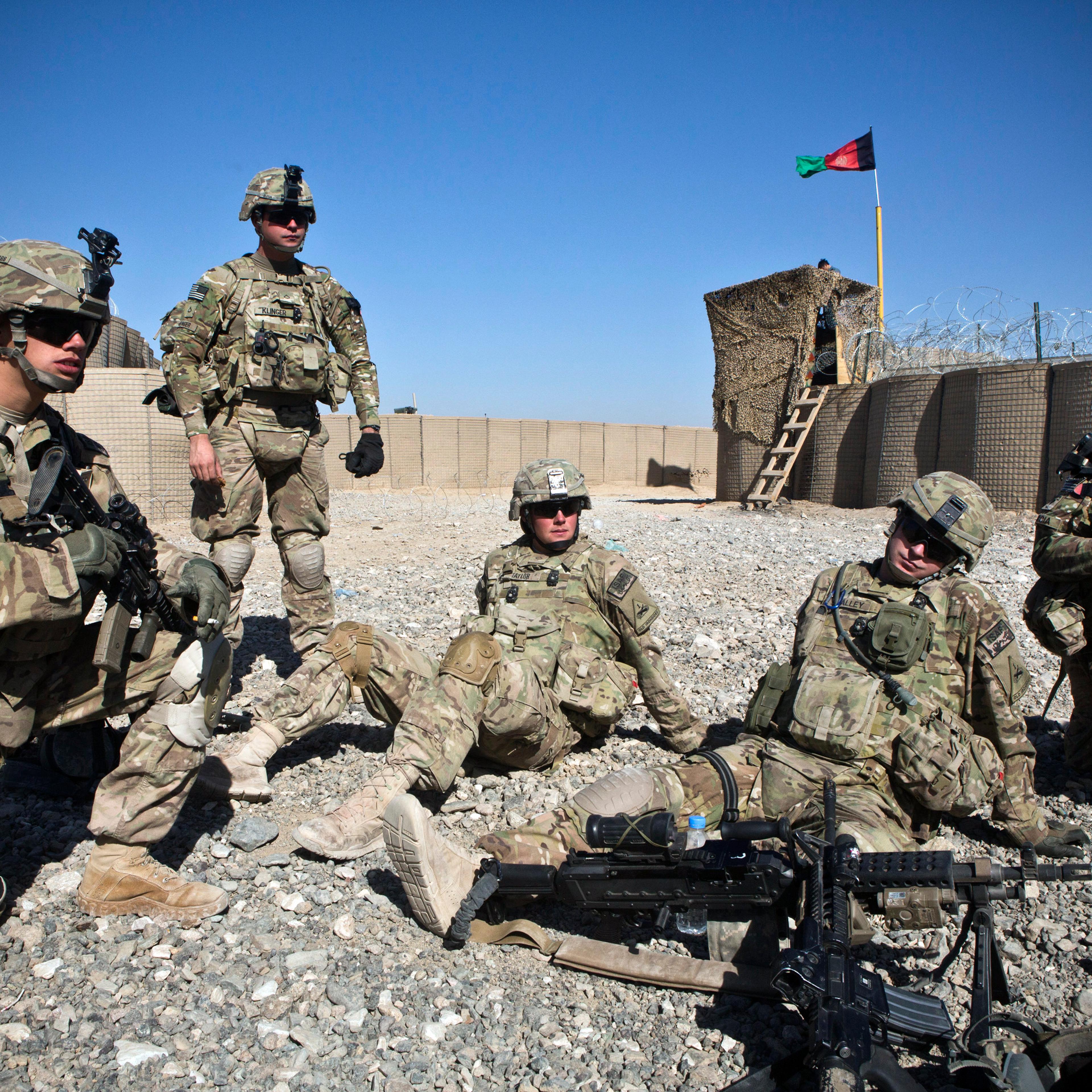 Soldiers with the U.S. Army's Bravo Company, 1st Battalion, 36th Infantry Regiment rest in an Afgan National Police compound before going on patrol near Command Outpost AJK (short for Azim-Jan-Kariz - a near-by village) in Maiwand District