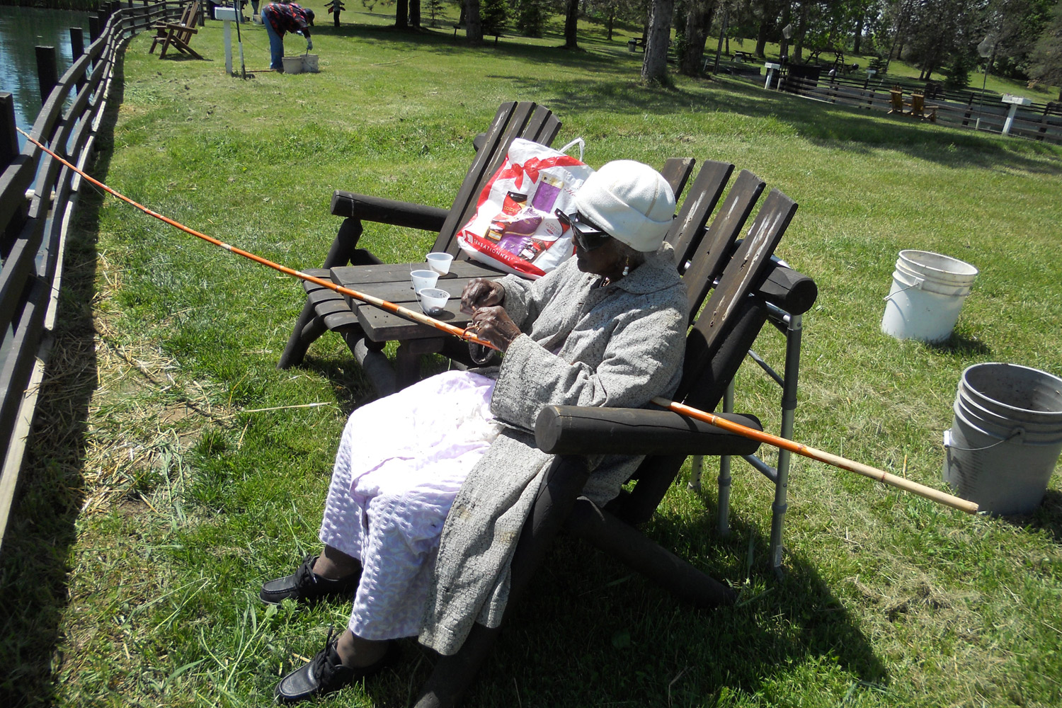 Talley puts the bait on her fishing pole at the Spring Valley Trout Farm in Dexter, Michigan, May 25, 2013.