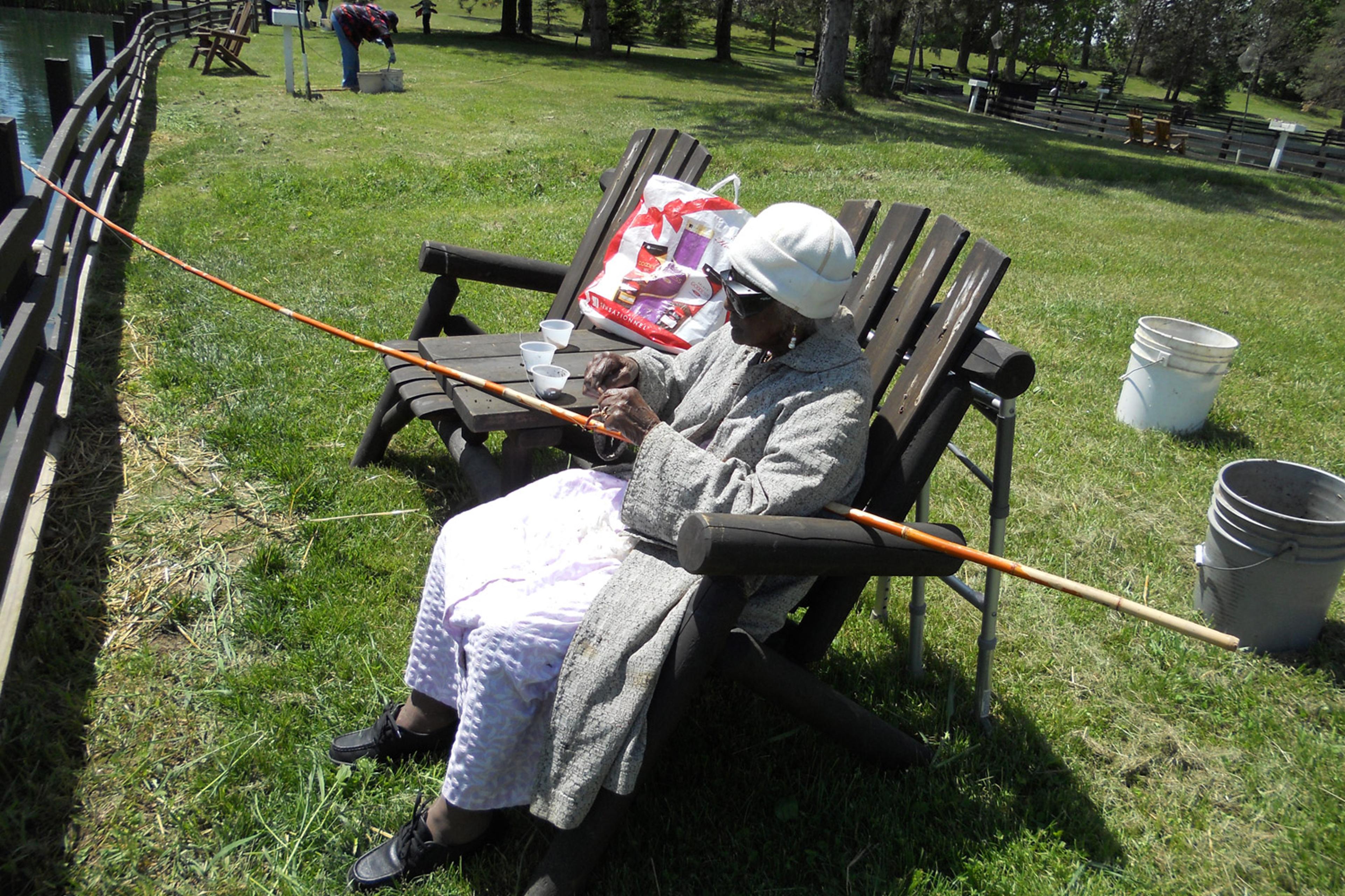 Talley puts the bait on her fishing pole at the Spring Valley Trout Farm in Dexter, Michigan, May 25, 2013.