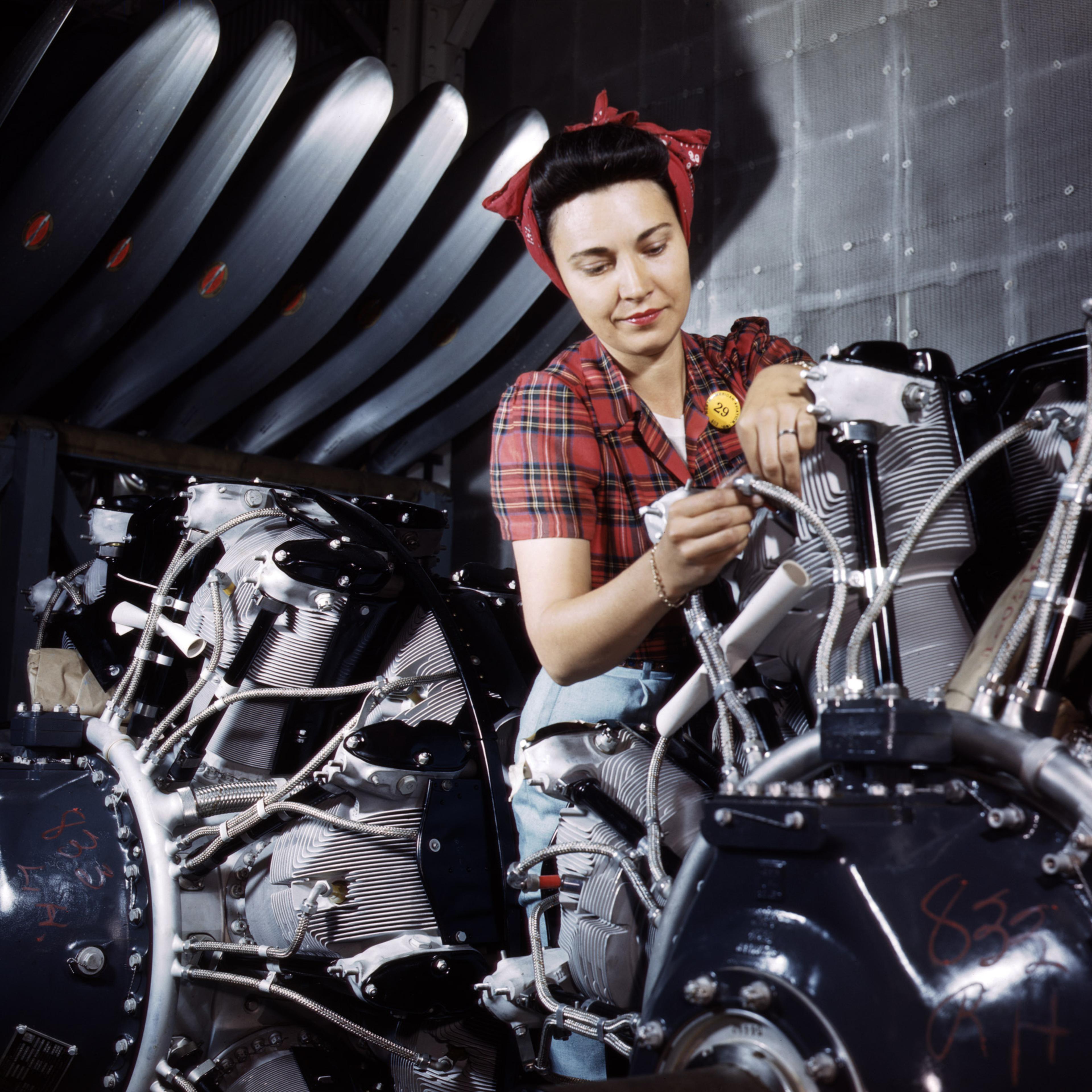 Woman working on an airplane motor at North American Aviation, Inc., plant in California, June 1942. Photographed by Alfred T. Palmer for the Farm Security Administration.