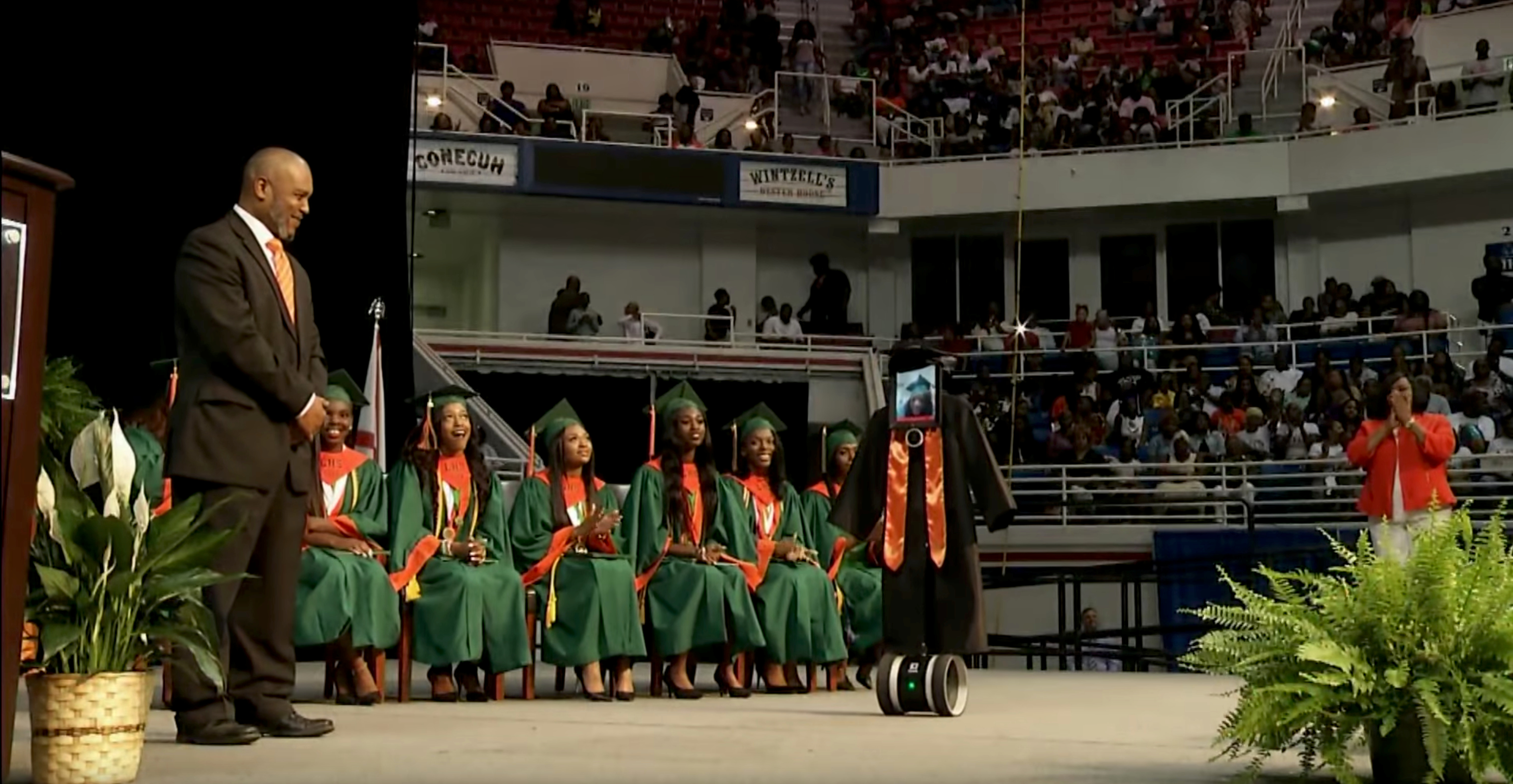 A robot with an iPad 'receiving' Hight School diploma as student Cynthia Pettway, who was unable to leave a hospital for the ceremony, is seen in Mobile, Alabama