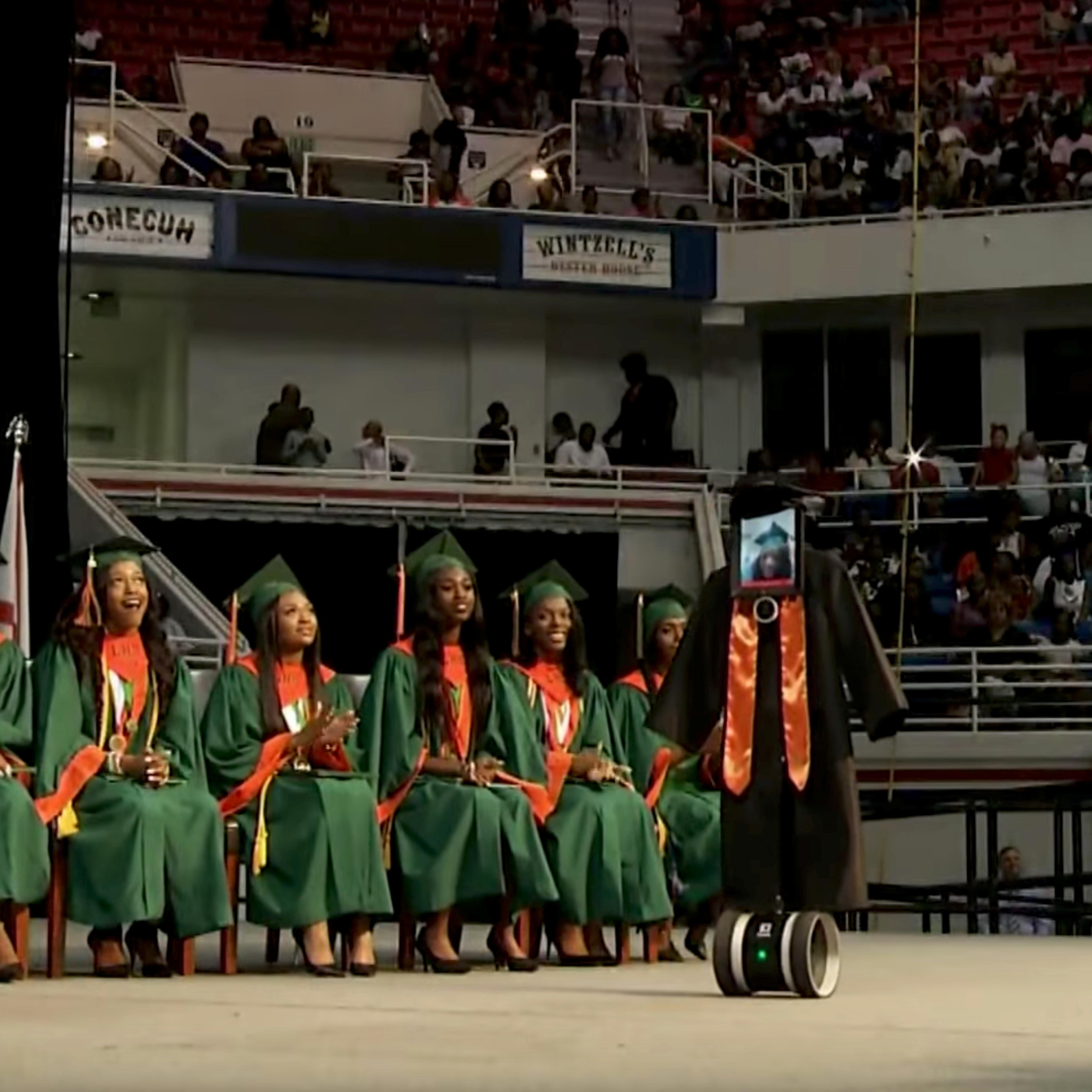 A robot with an iPad 'receiving' Hight School diploma as student Cynthia Pettway, who was unable to leave a hospital for the ceremony, is seen in Mobile, Alabama
