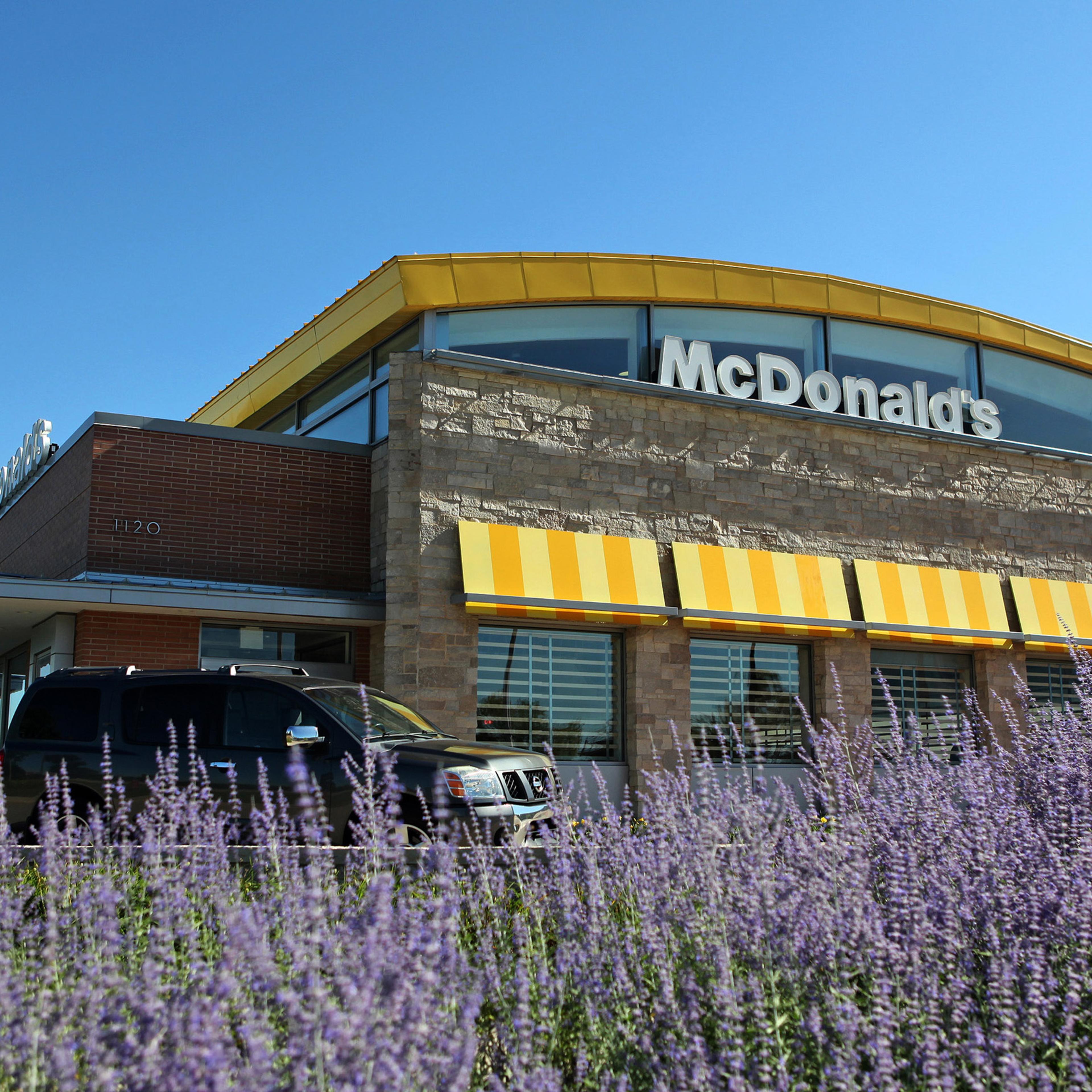 A car passes in front a McDonald's Corp. restaurant in Oak Brook, Illinois, U.S., on July 12, 2013.