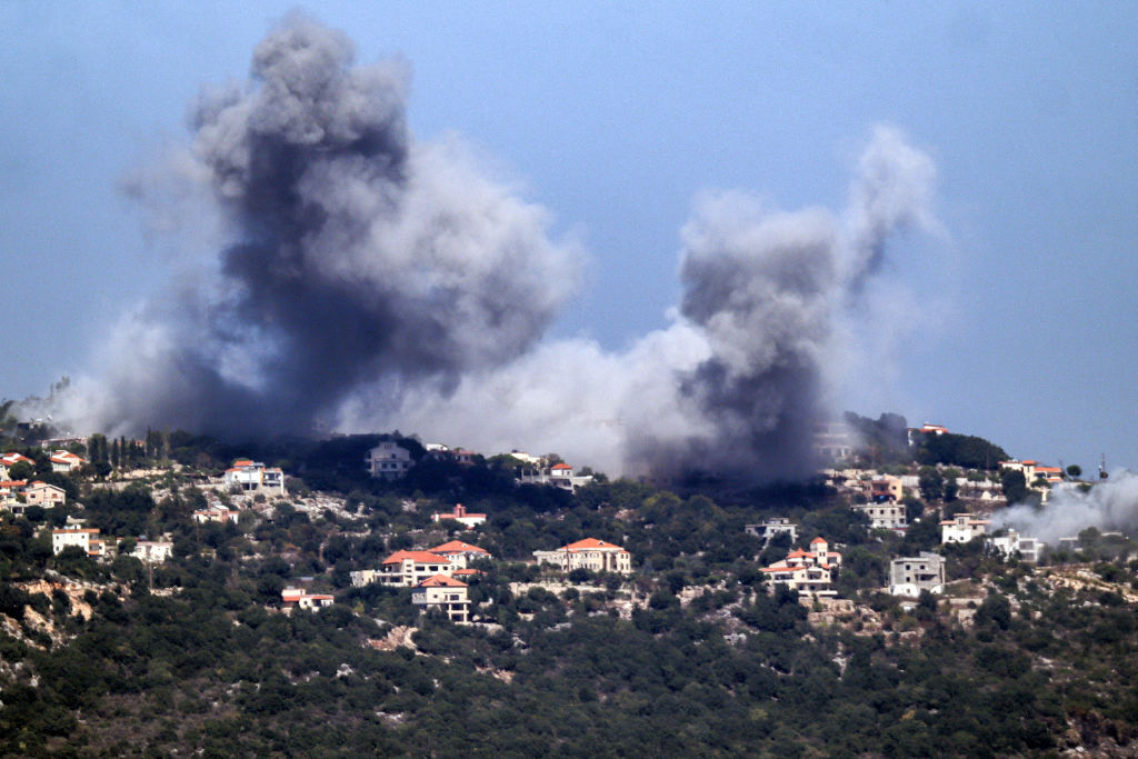 A cloud of smoke erupts during an Israeli air strike on the village of Sujud in southern Lebanon on Sept. 25, 2024.