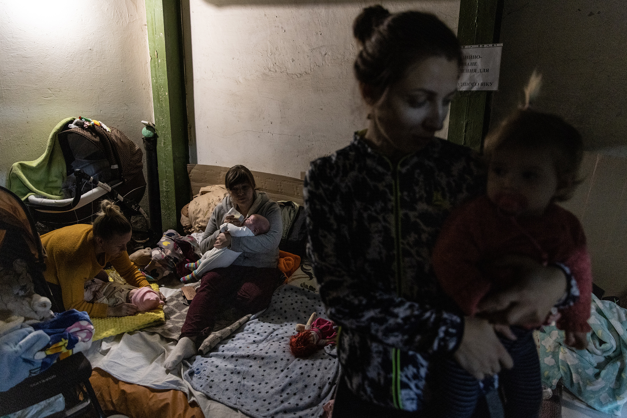 Mothers tend to their babies that are undergoing medical treatment in the bomb shelter of the pediatric ward of Okhmatdyt Children's Hospital on Feb. 28 in Kyiv