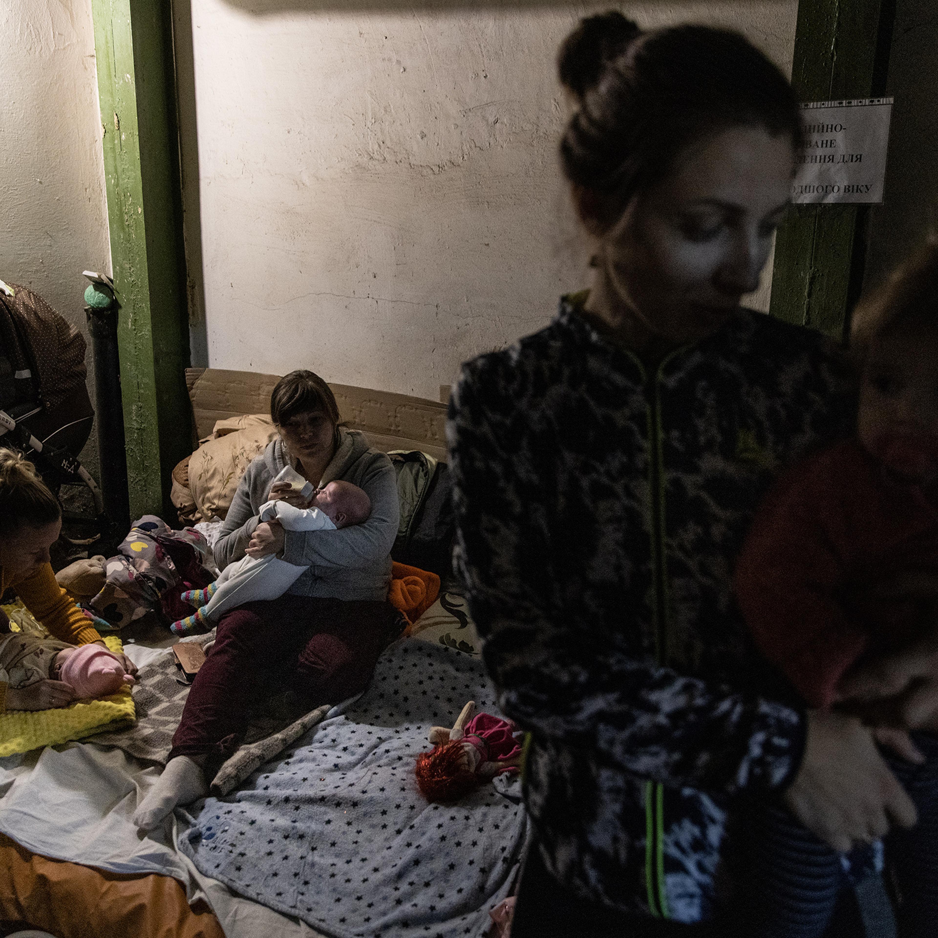 Mothers tend to their babies that are undergoing medical treatment in the bomb shelter of the pediatric ward of Okhmatdyt Children's Hospital on Feb. 28 in Kyiv