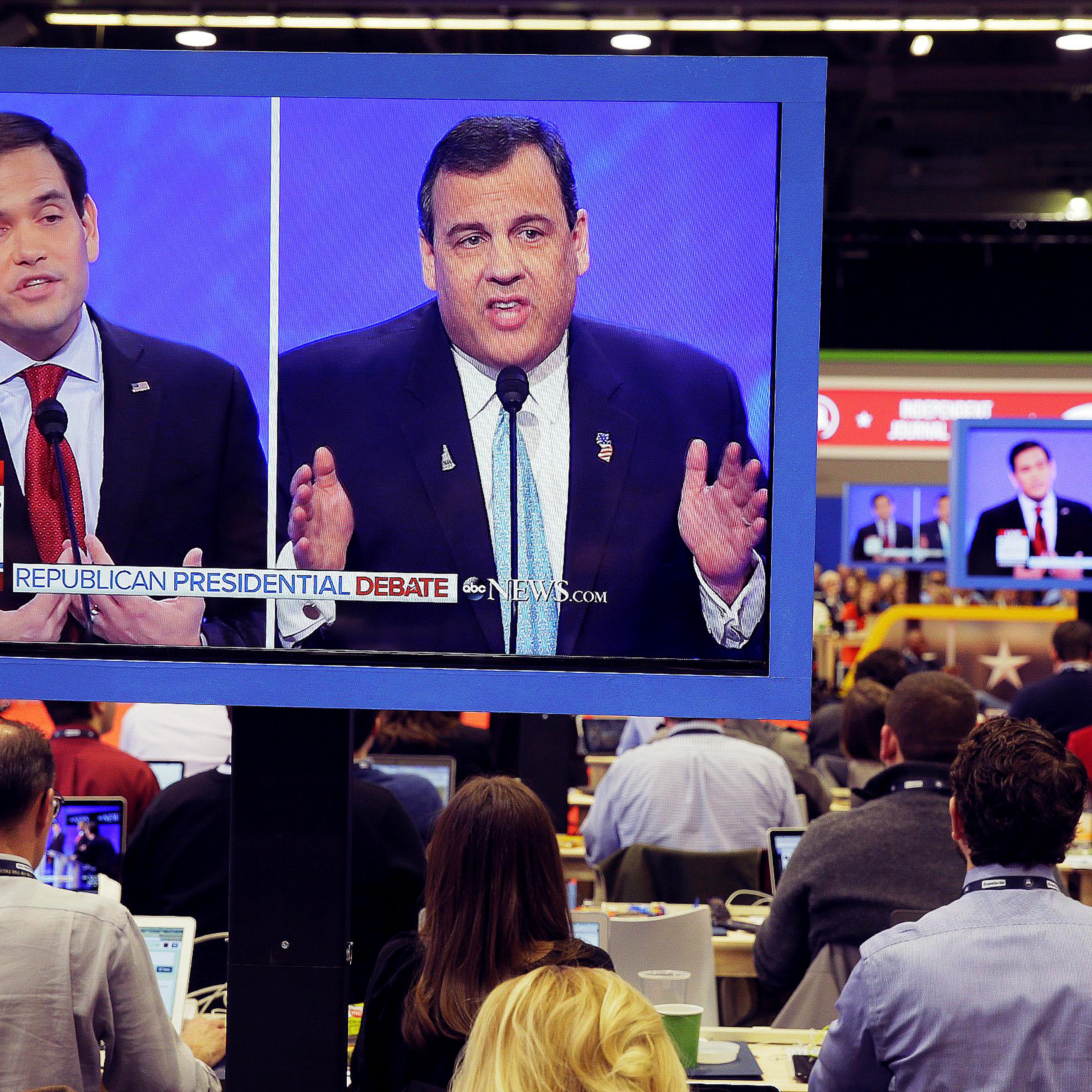 Republican presidential candidates Sen. Marco Rubio (r-FL) and New Jersey Gov. Chris Christie are seen on press room television monitors during a Republican presidential debate on Feb. 6, 2016 at Saint Anselm College in Manchester, N.H.