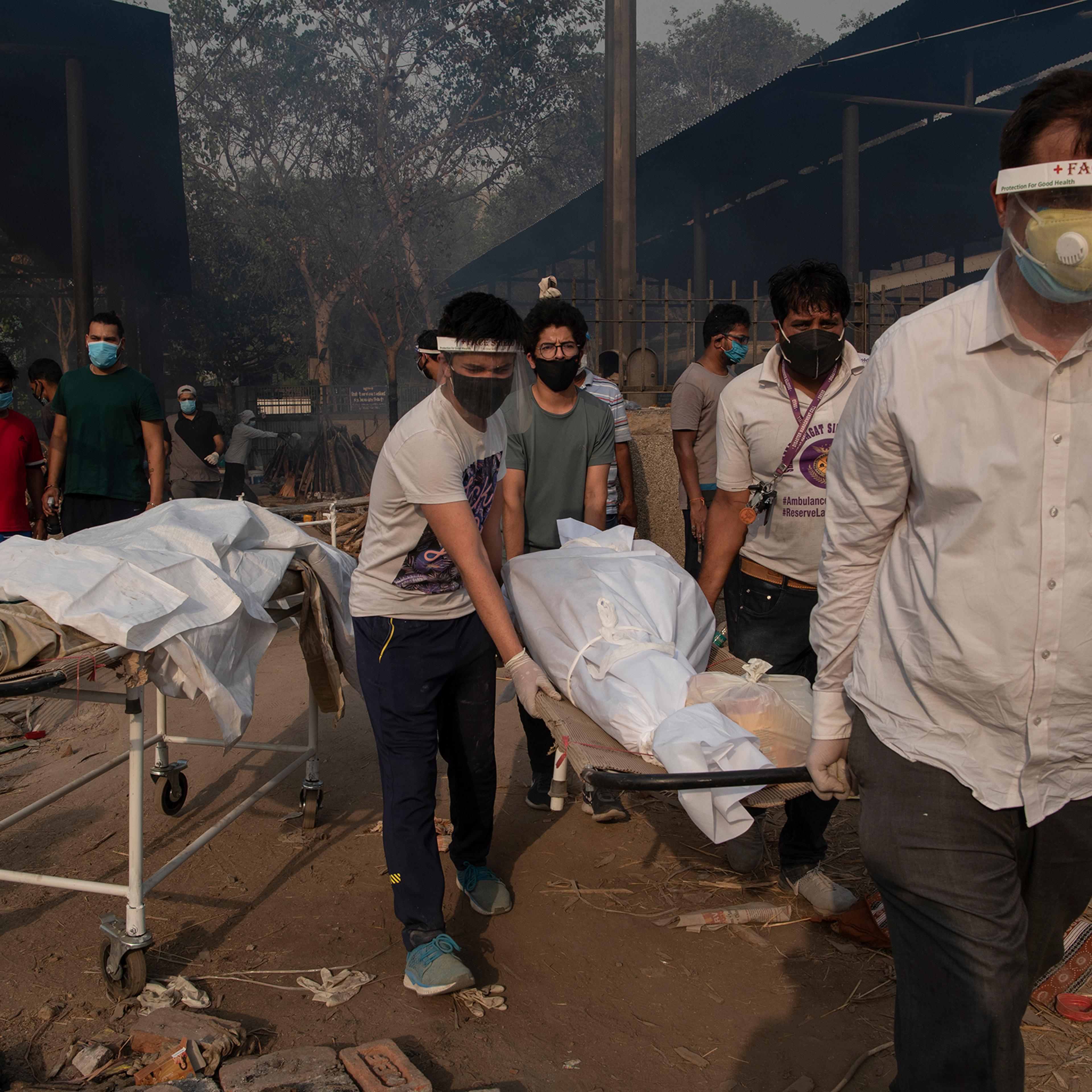 Relatives carry the body of a loved one at a crematorium in New Delhi on April 27, as India endures the world's worst COVID-19 outbreak.
