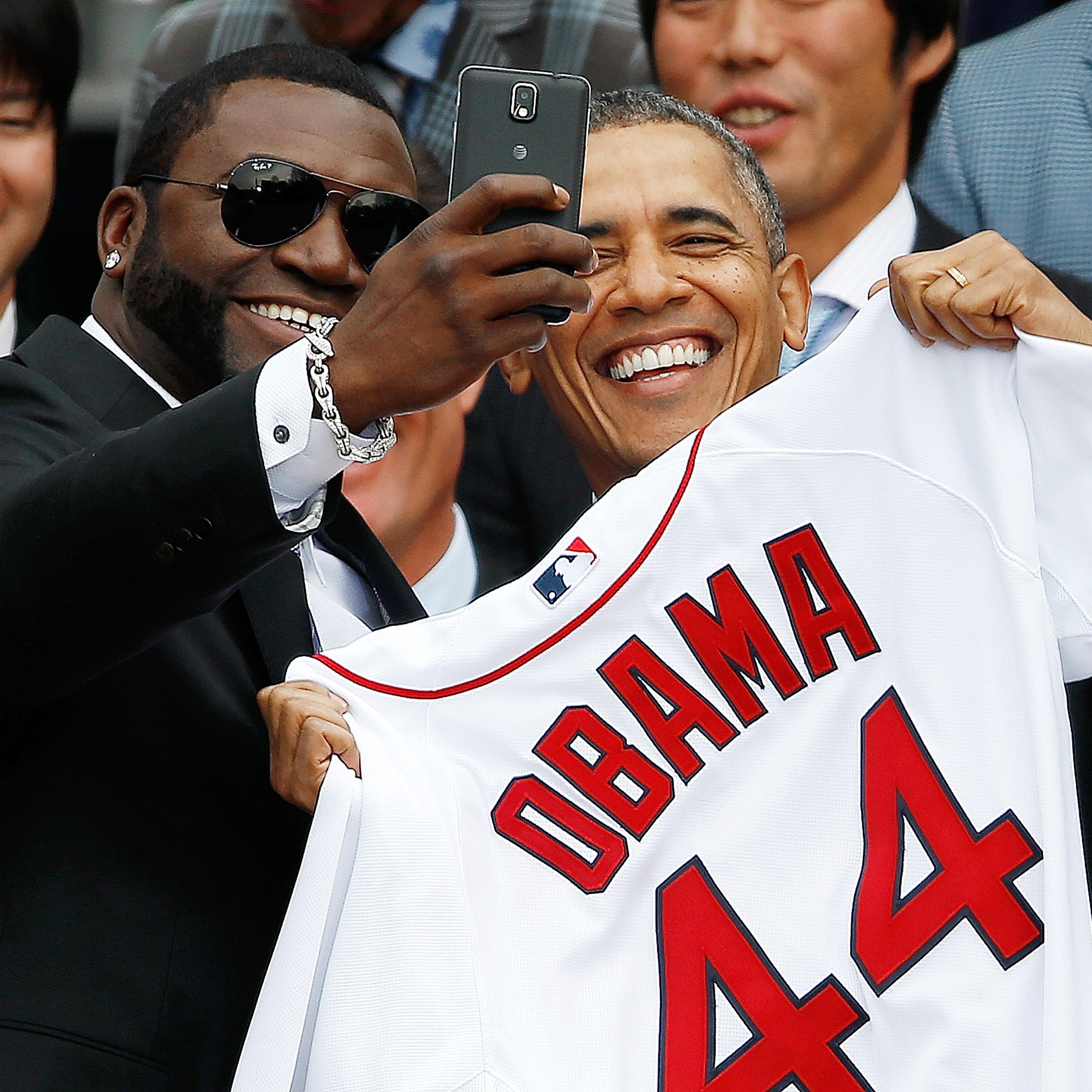 WASHINGTON, DC - APRIL 01: Boston Red Sox designated hitter David Ortiz (L) poses for a "selfie" with U.S. President Barack Obama during a ceremony on the South Lawn of the White House to honor the 2013 World Series Champion Boston Red Sox April 1, 2014