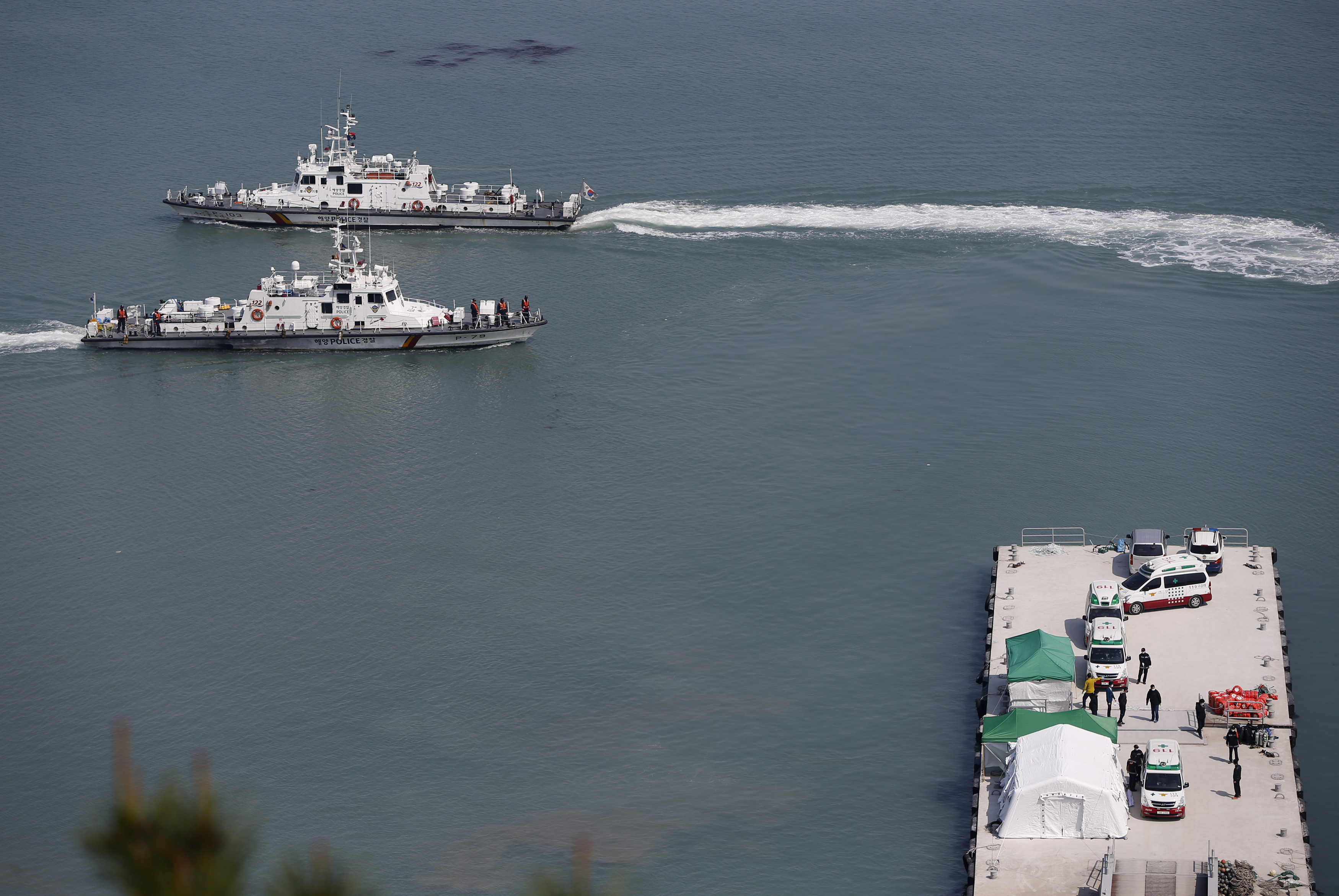 A South Korean coast guard vessel carrying the body of a passenger who was on the capsized passenger ship Sewol which sank in the sea off Jindo, approaches to a pier at a port in Jindo