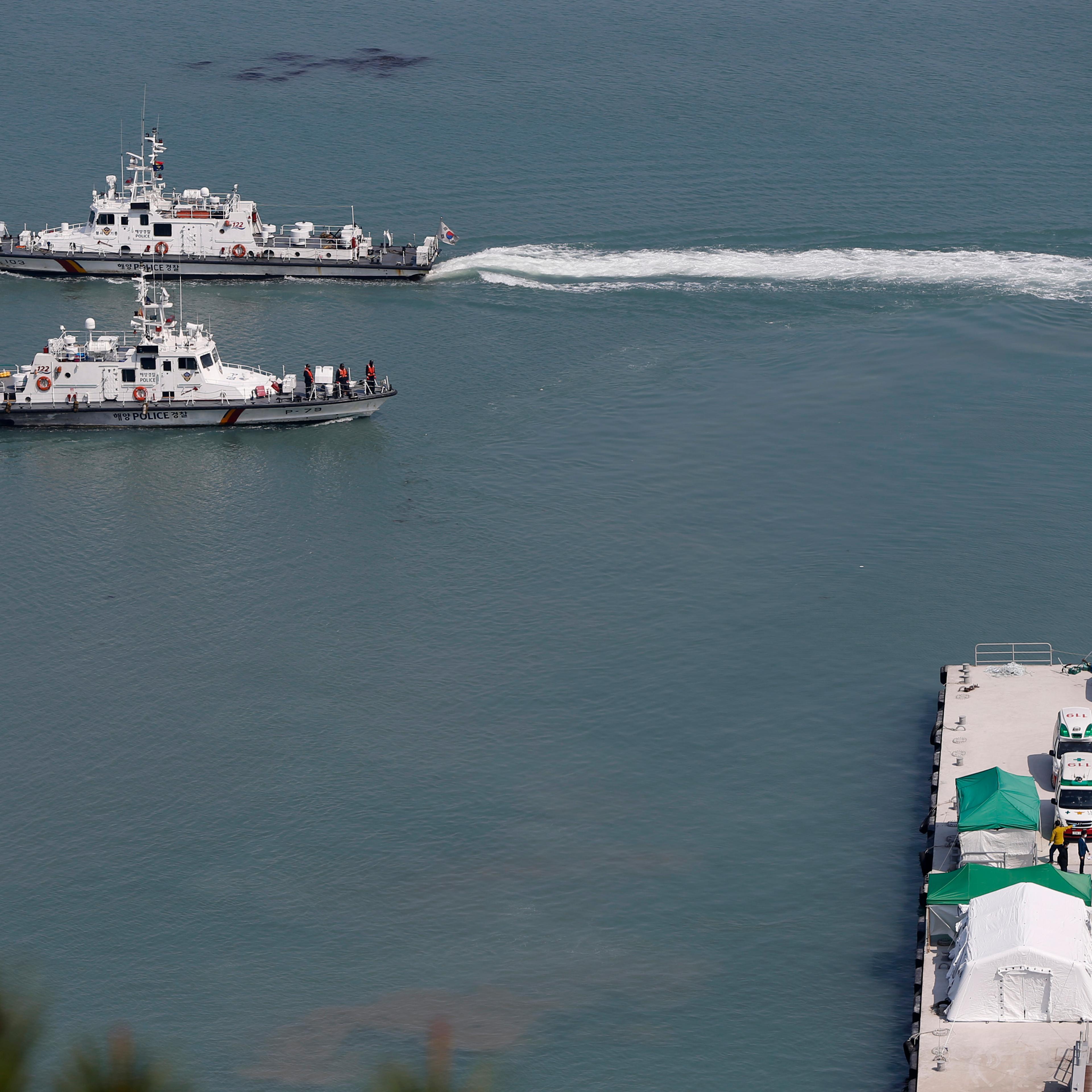 A South Korean coast guard vessel carrying the body of a passenger who was on the capsized passenger ship Sewol which sank in the sea off Jindo, approaches to a pier at a port in Jindo