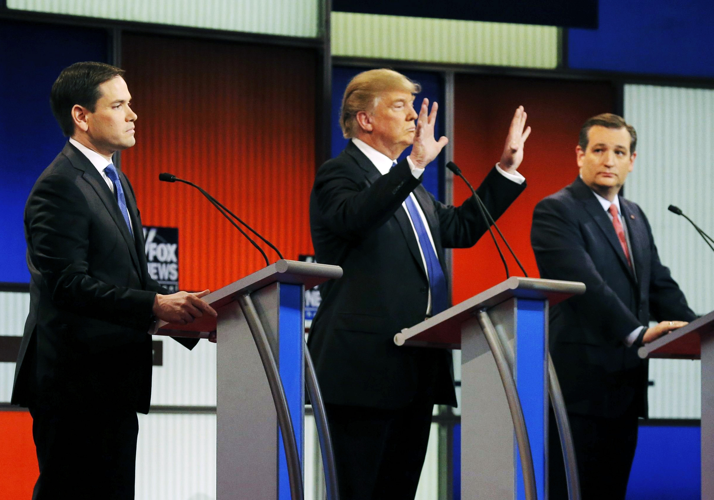 Republican presidential candidate Donald Trump shows off the size of his hands as Florida Sen. Marco Rubio, left, and Texas Sen. Ted Cruz watch during a debate in Detroit, on March 3.