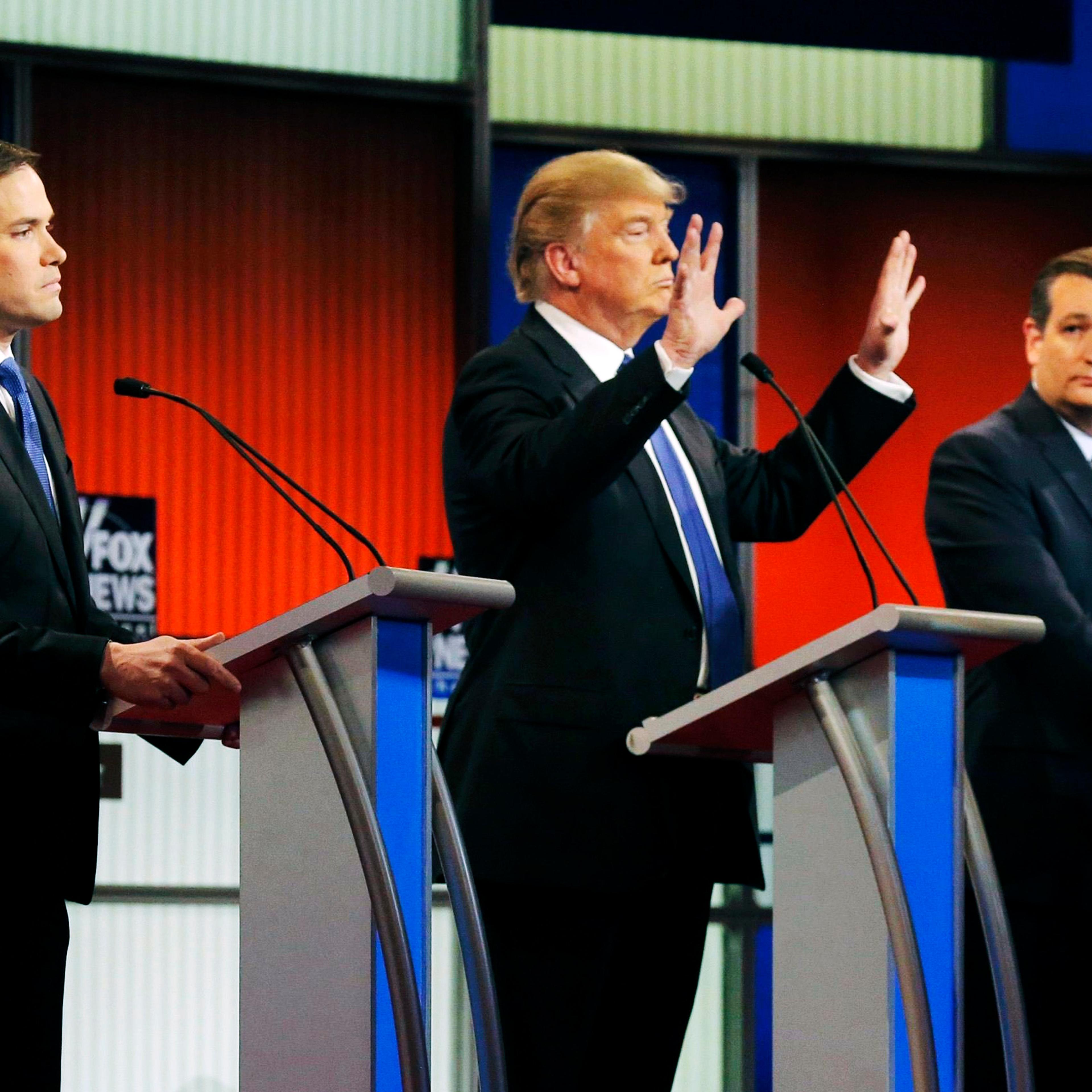 Republican presidential candidate Donald Trump shows off the size of his hands as Florida Sen. Marco Rubio, left, and Texas Sen. Ted Cruz watch during a debate in Detroit, on March 3.