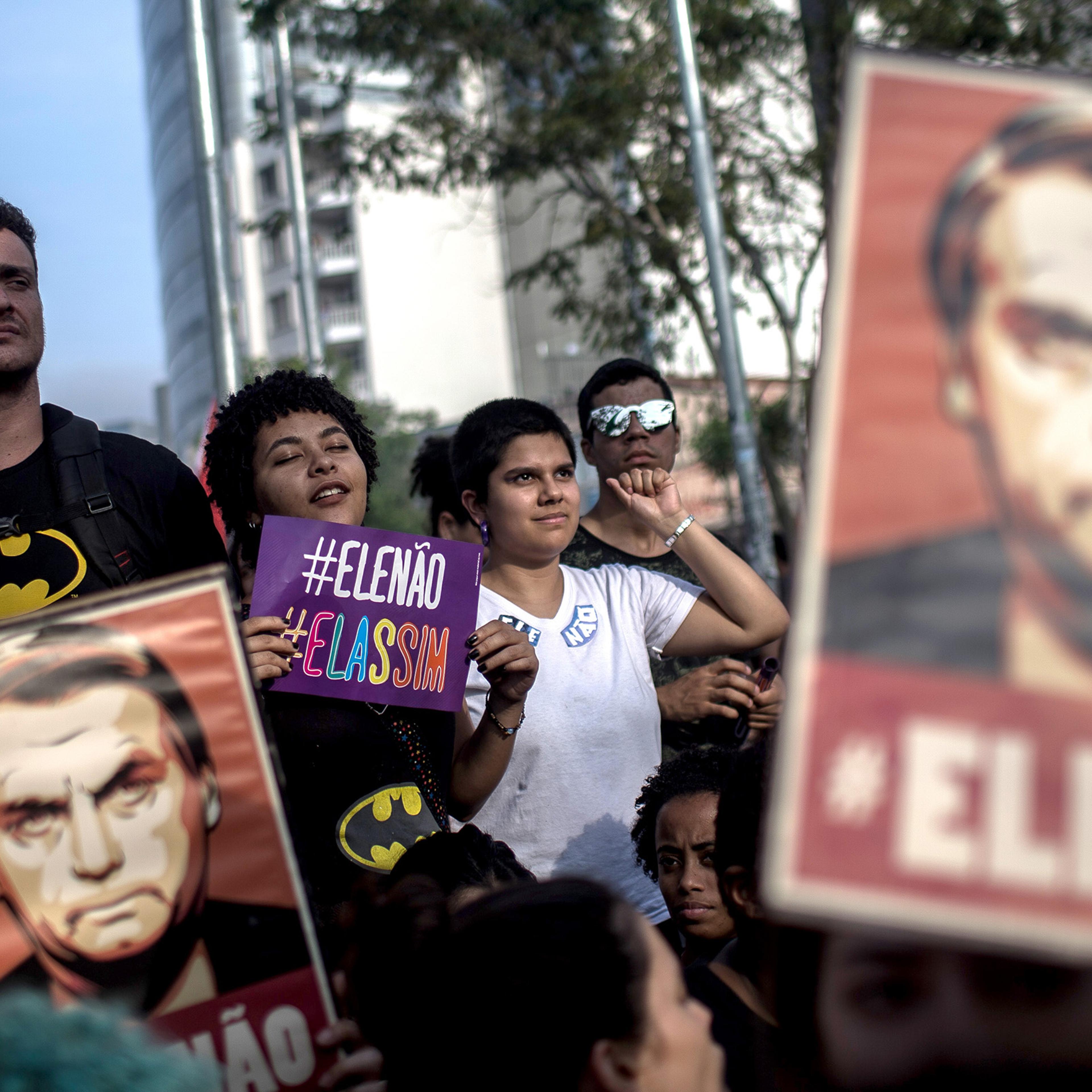 Protesters carry posters against the far-right’s presidential candidate Jair Bolsonaro in Sao Paulo, Brazil on Sept. 29, 2018.