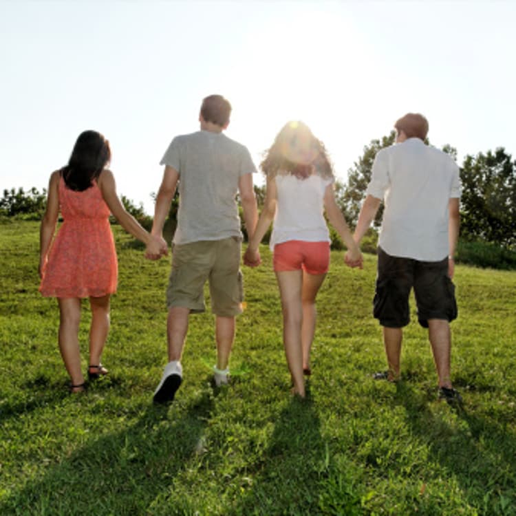 young-adults-walking-holding-hands