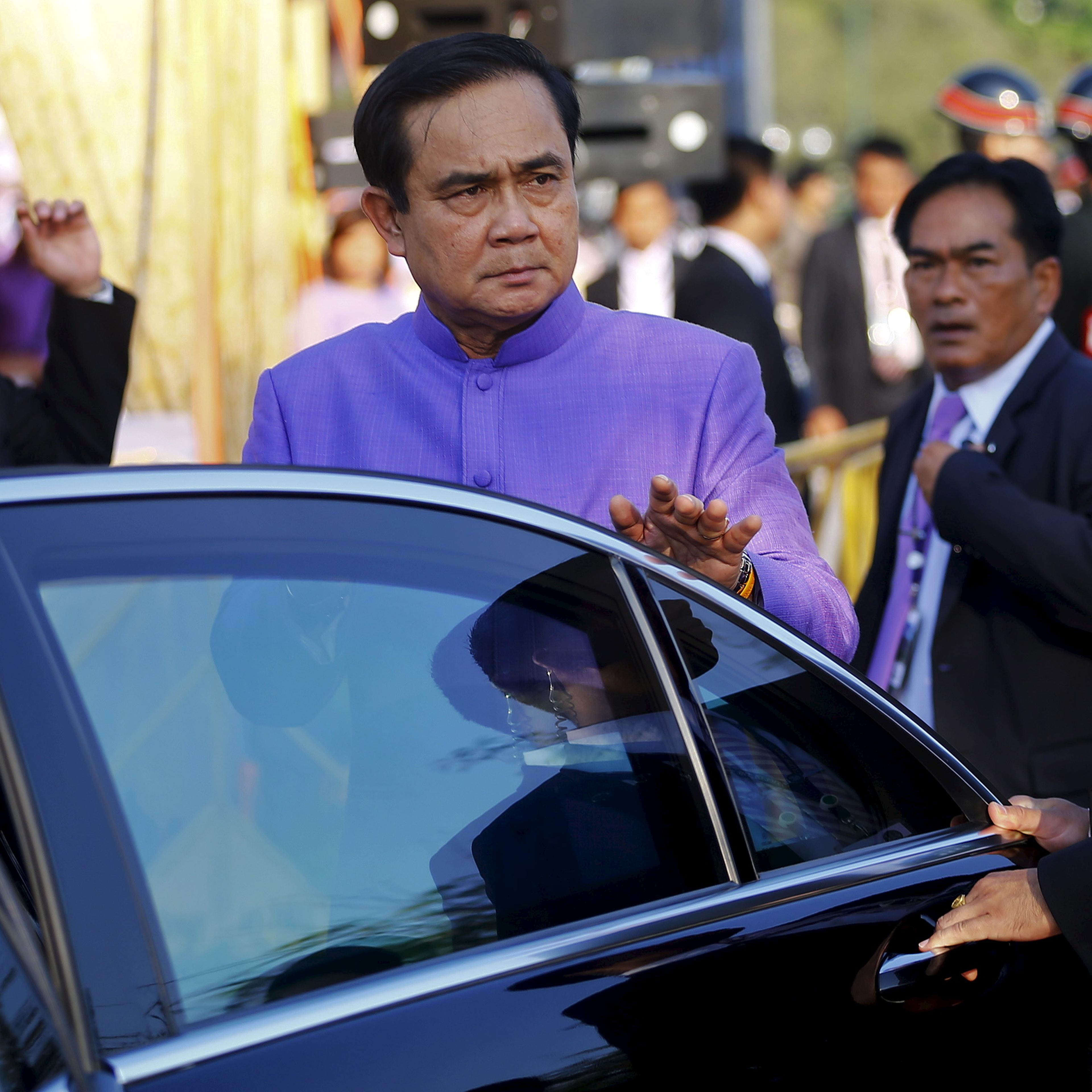 Prime Minister Prayuth Chan-ocha gets in his car after the merit-making ceremony on the occasion of Princess Maha Chakri Sirindhorn's birthday at Sanam Luang in Bangkok