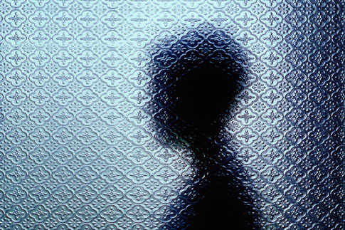 Silhouetted person through window