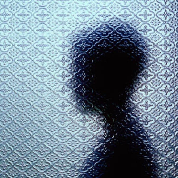 Silhouetted person through window