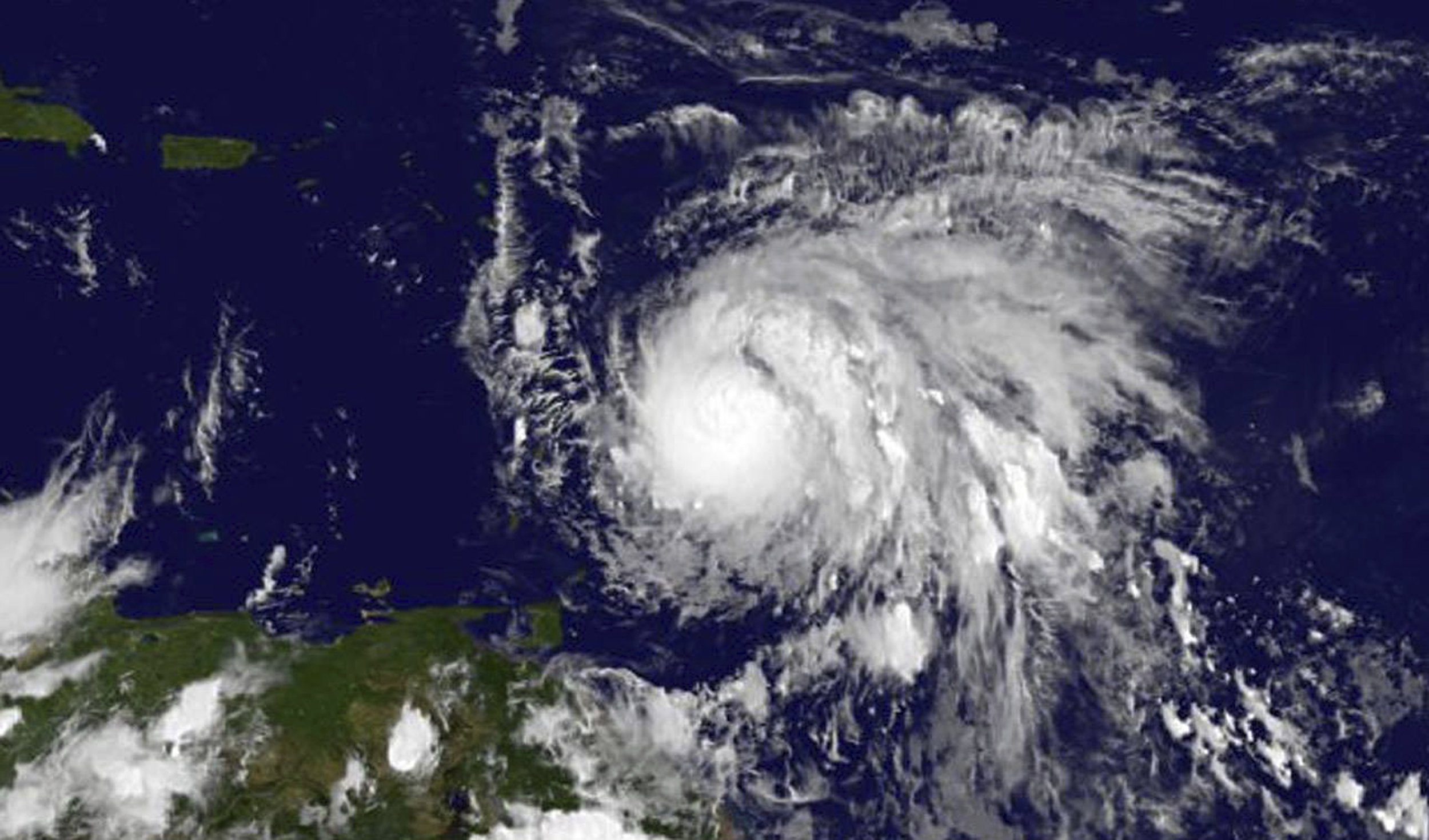 Sept. 17, 2017, GOES East satellite image provided by NASA taken at 7:45 p.m EDT, shows Hurricane Maria as it approaches the Lesser Antilles. Maria swiftly grew into a hurricane Sunday, and forecasters said it was expected to become much stronger over th