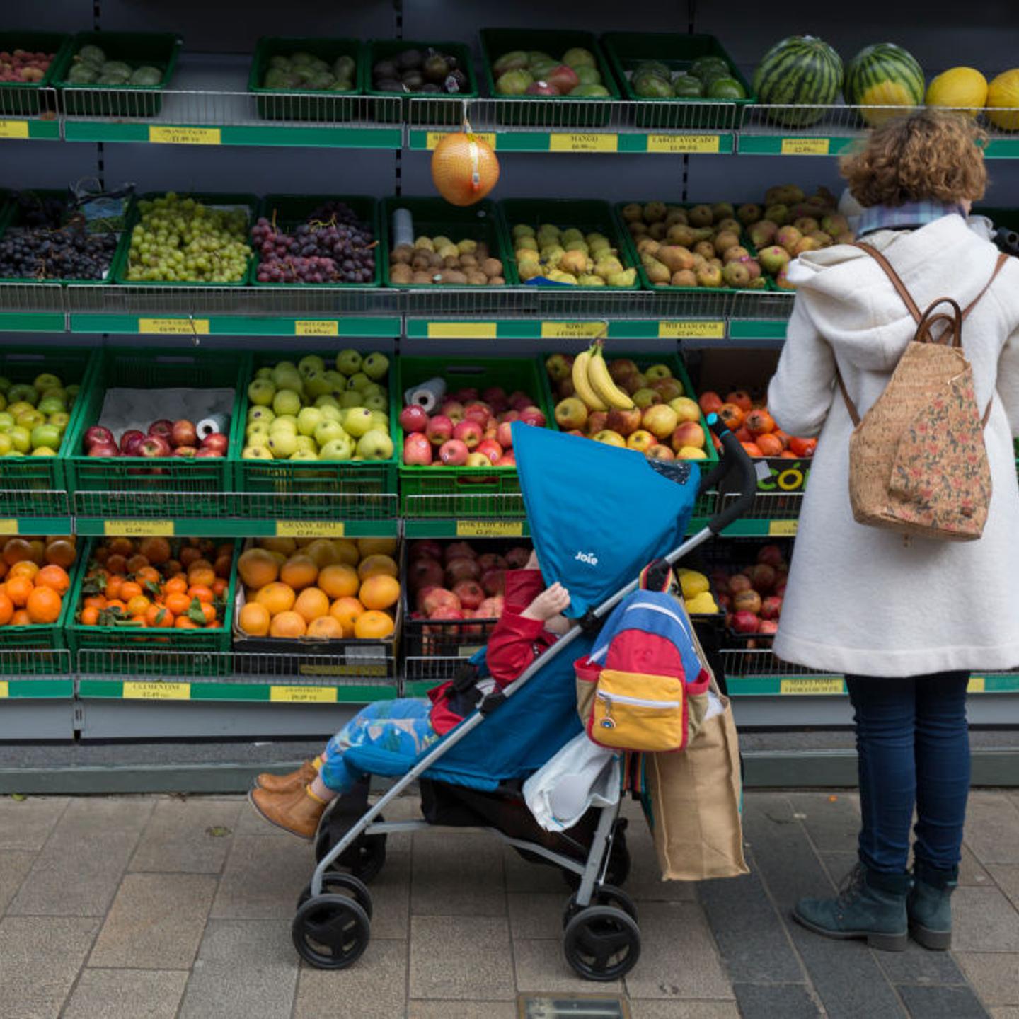 Mother Buys Fruit For Child