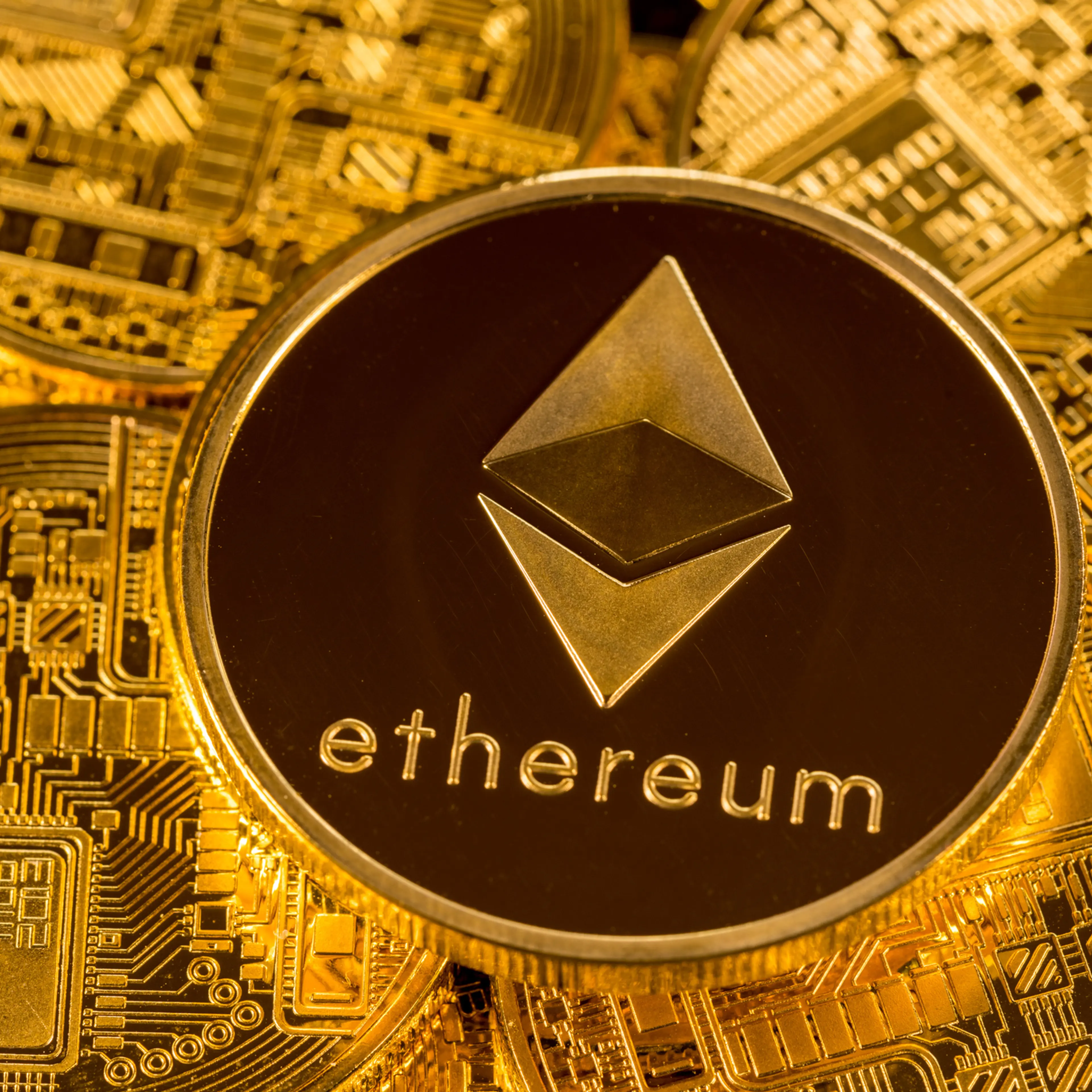 Stack of Ether coins with gold background