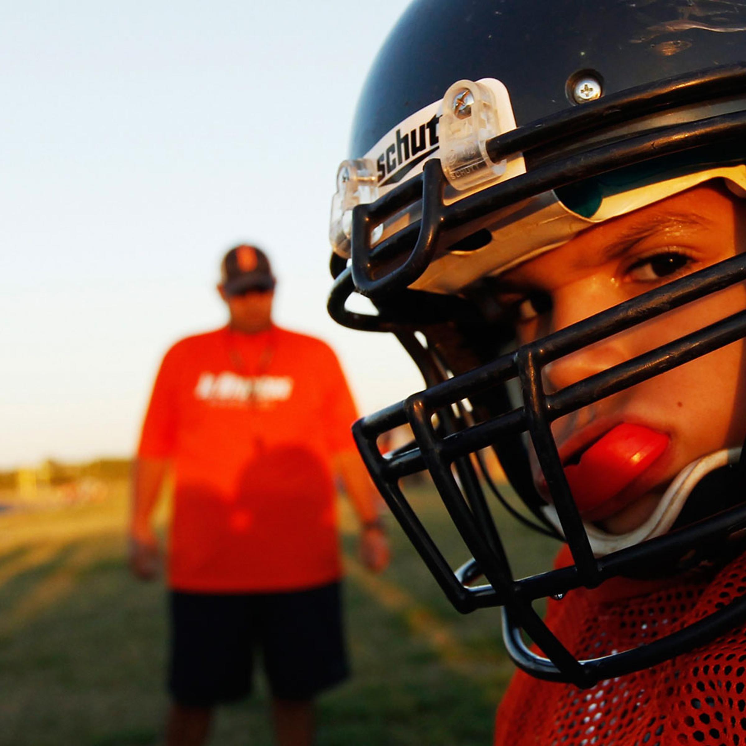 A youngster chews on his mouthguard during the filming of the television docu-series "Friday Night Tykes" in San Antonio, Texas.