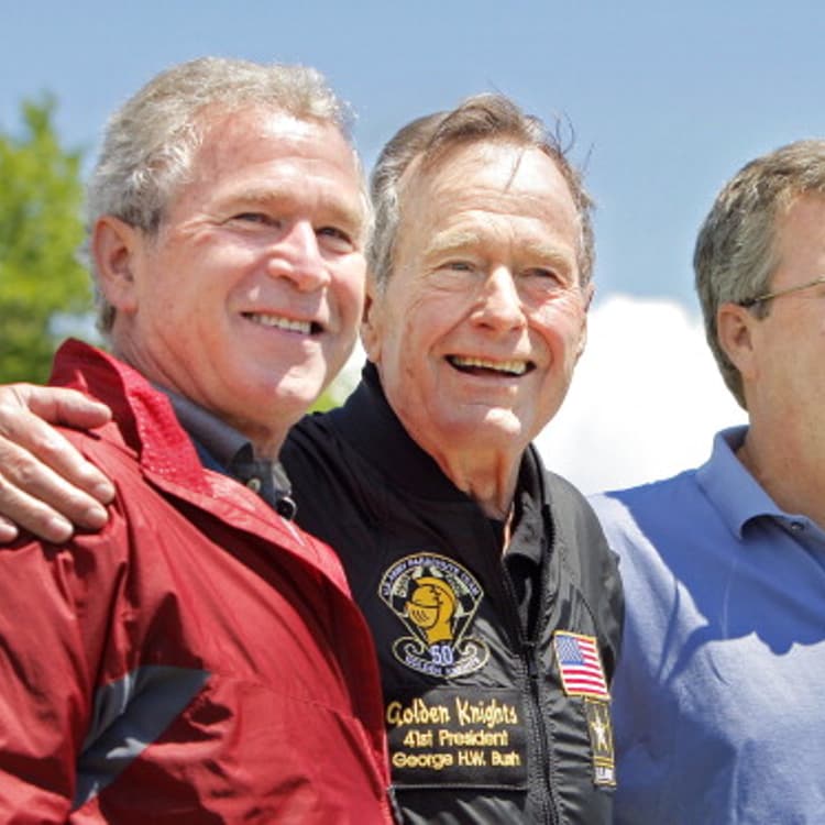 Former President George H. W. Bush poses with his sons former President George W. Bush and Jeb Bush.