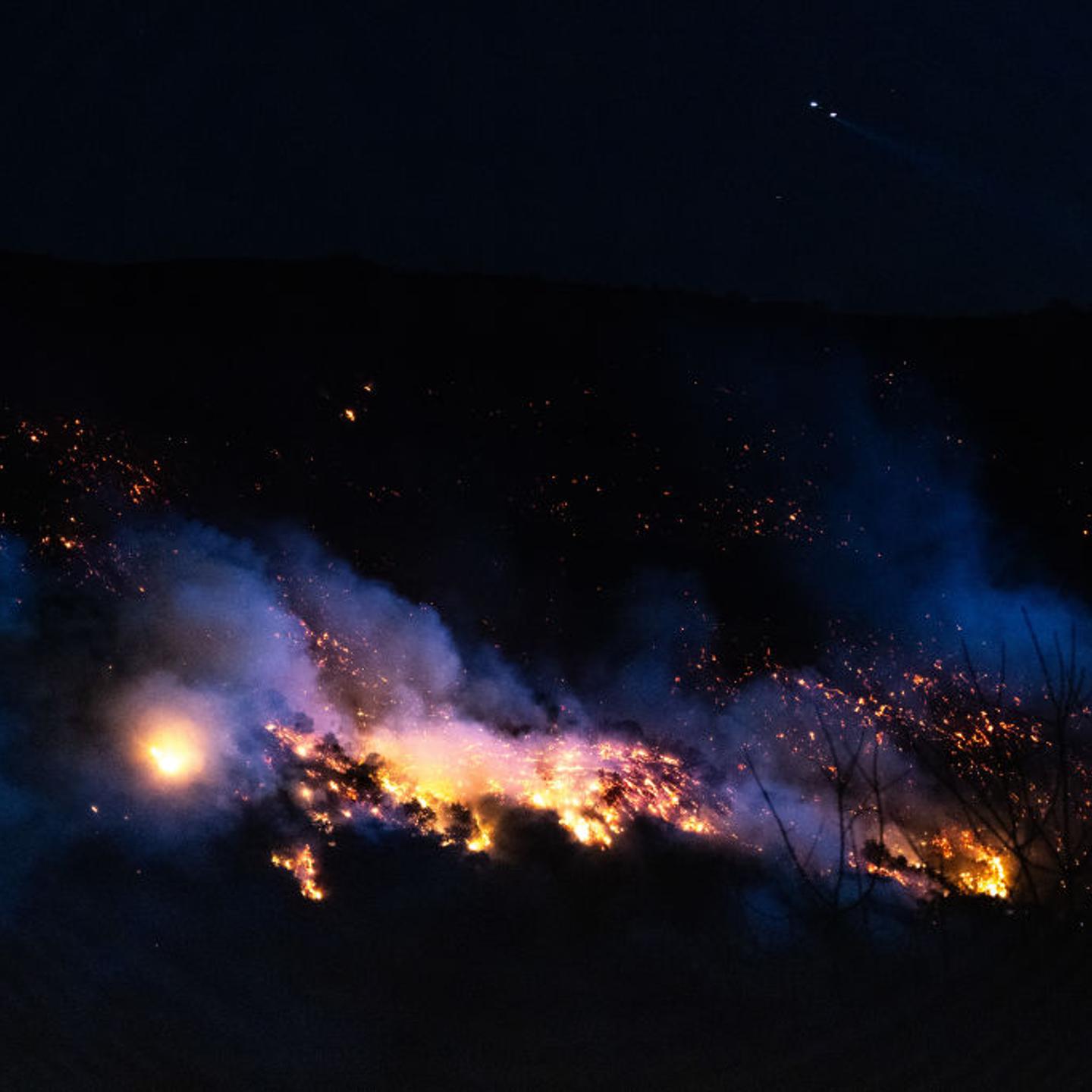 Fire glows along Mandeville Canyon during the Palisades Fire, photographed from the Mountaingate development, above Mandeville, in the Brentwood community of Los Angeles, Calif. on on Jan. 11, 2025.