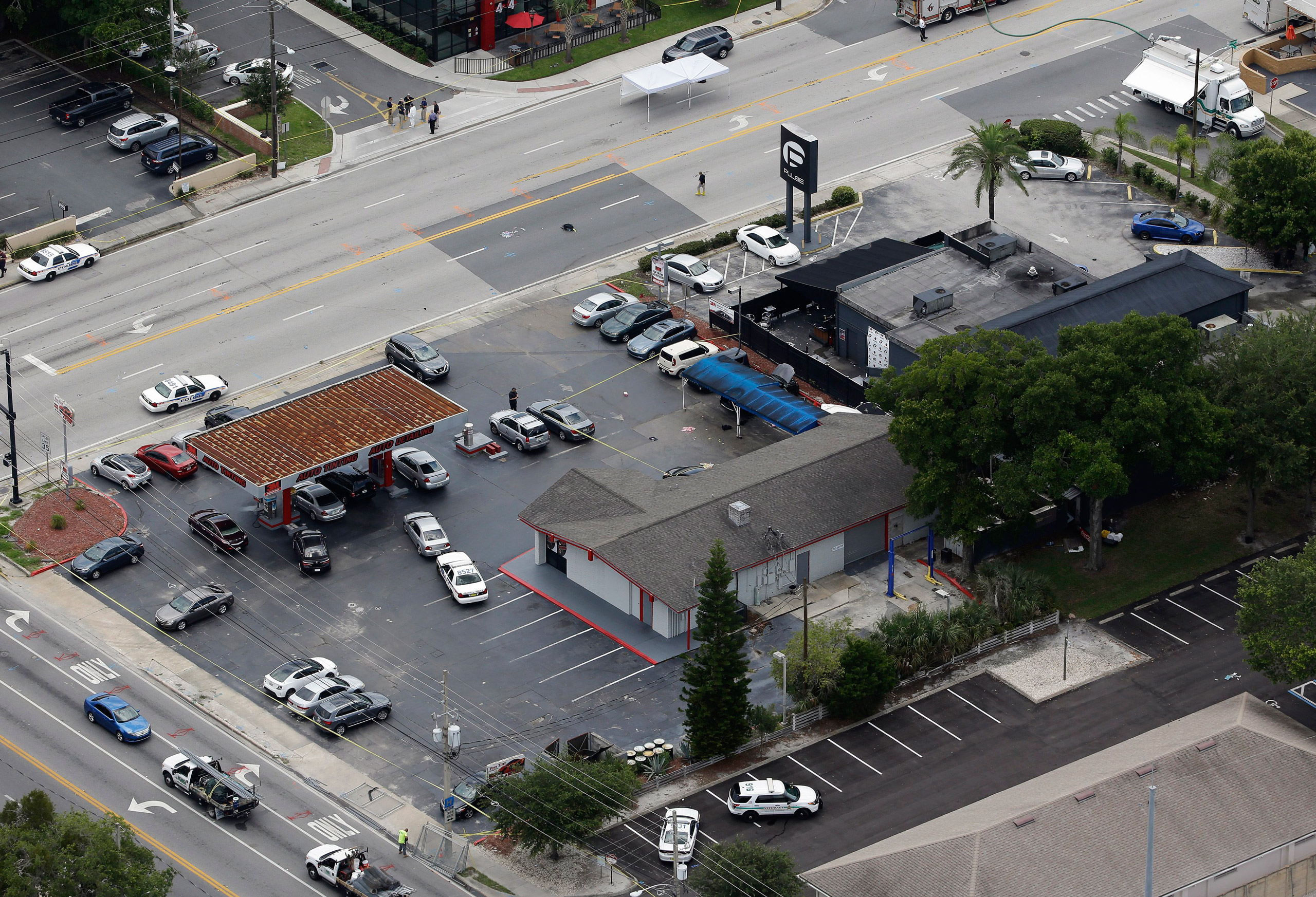 Law enforcement officials work at the Pulse nightclub following a fatal shooting Sunday, June 12, 2016, in Orlando, Fla. . (AP Photo/Chris O'Meara)