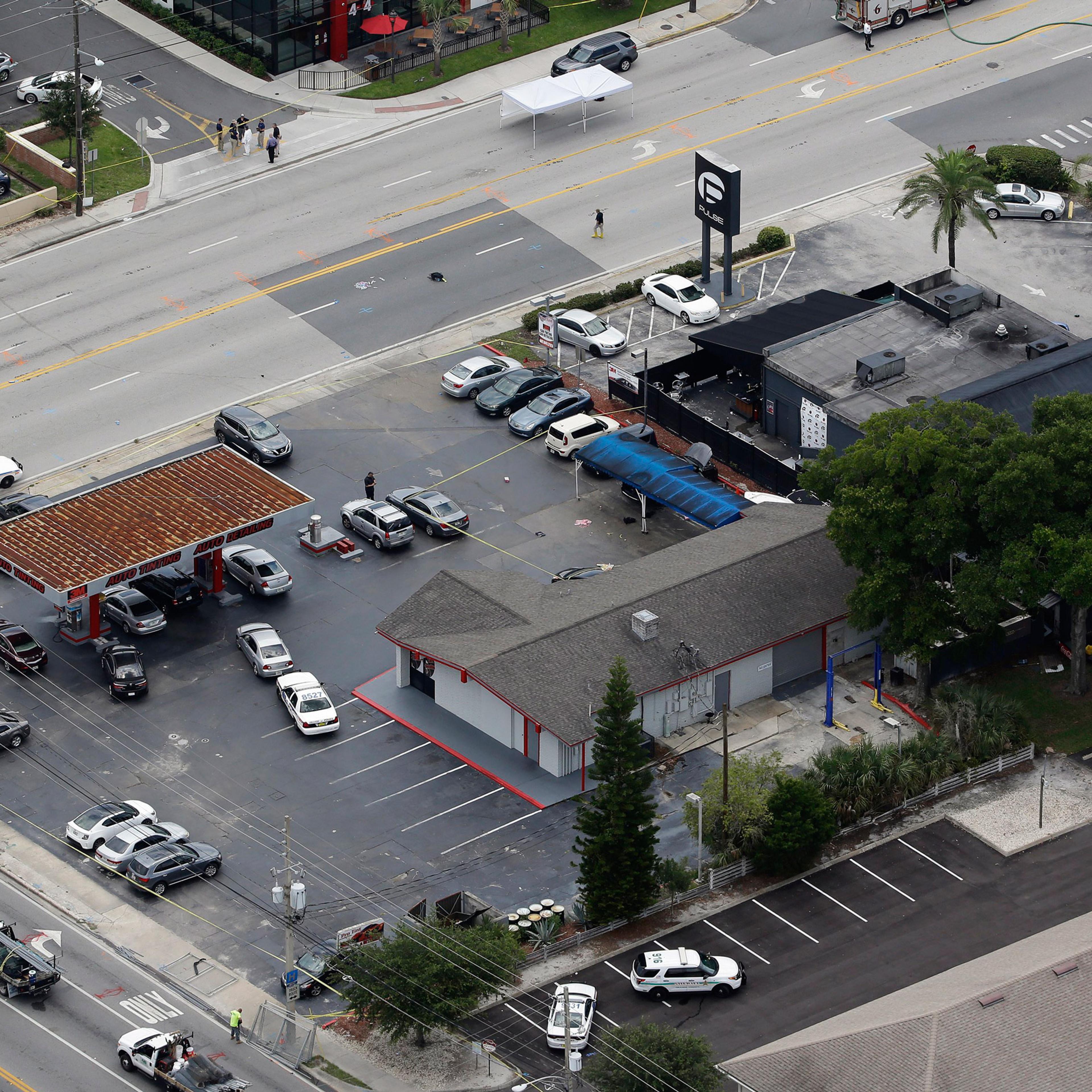 Law enforcement officials work at the Pulse nightclub following a fatal shooting Sunday, June 12, 2016, in Orlando, Fla. . (AP Photo/Chris O'Meara)