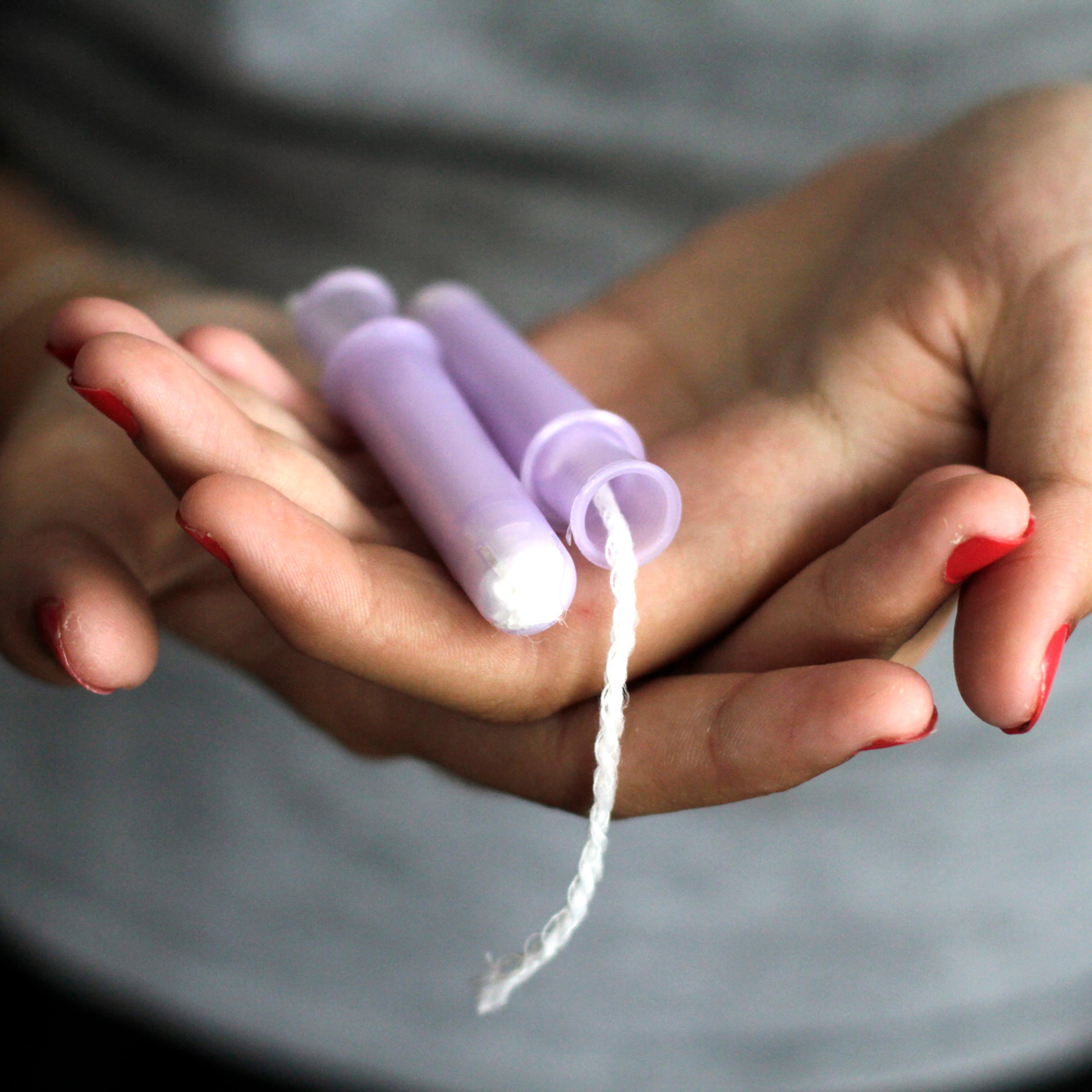 Close-Up Of Woman Hand Holding Tampons