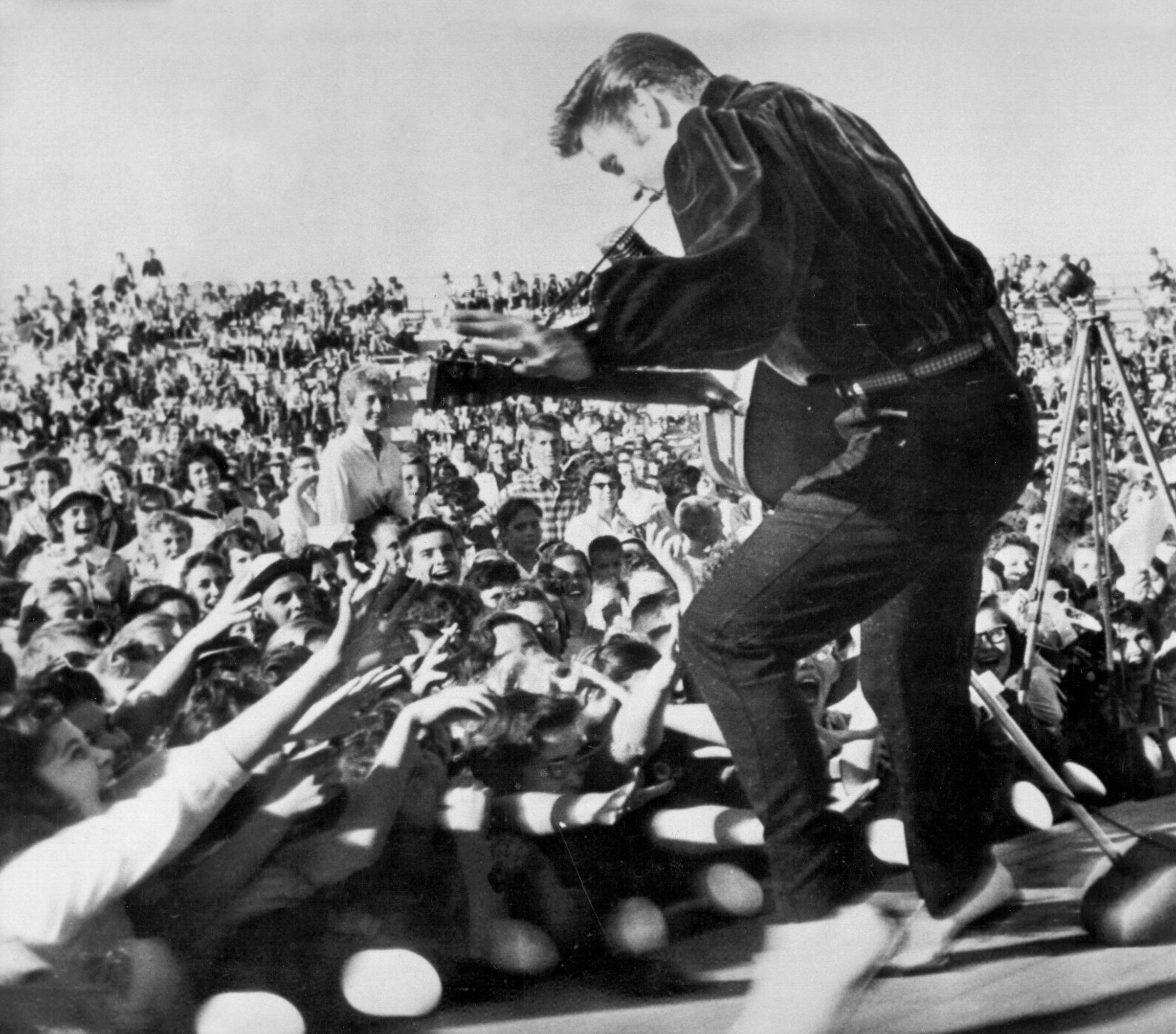 Elvis performs outside to adoring fans on September 26, 1956 in his hometown of Tupelo, Mississippi.