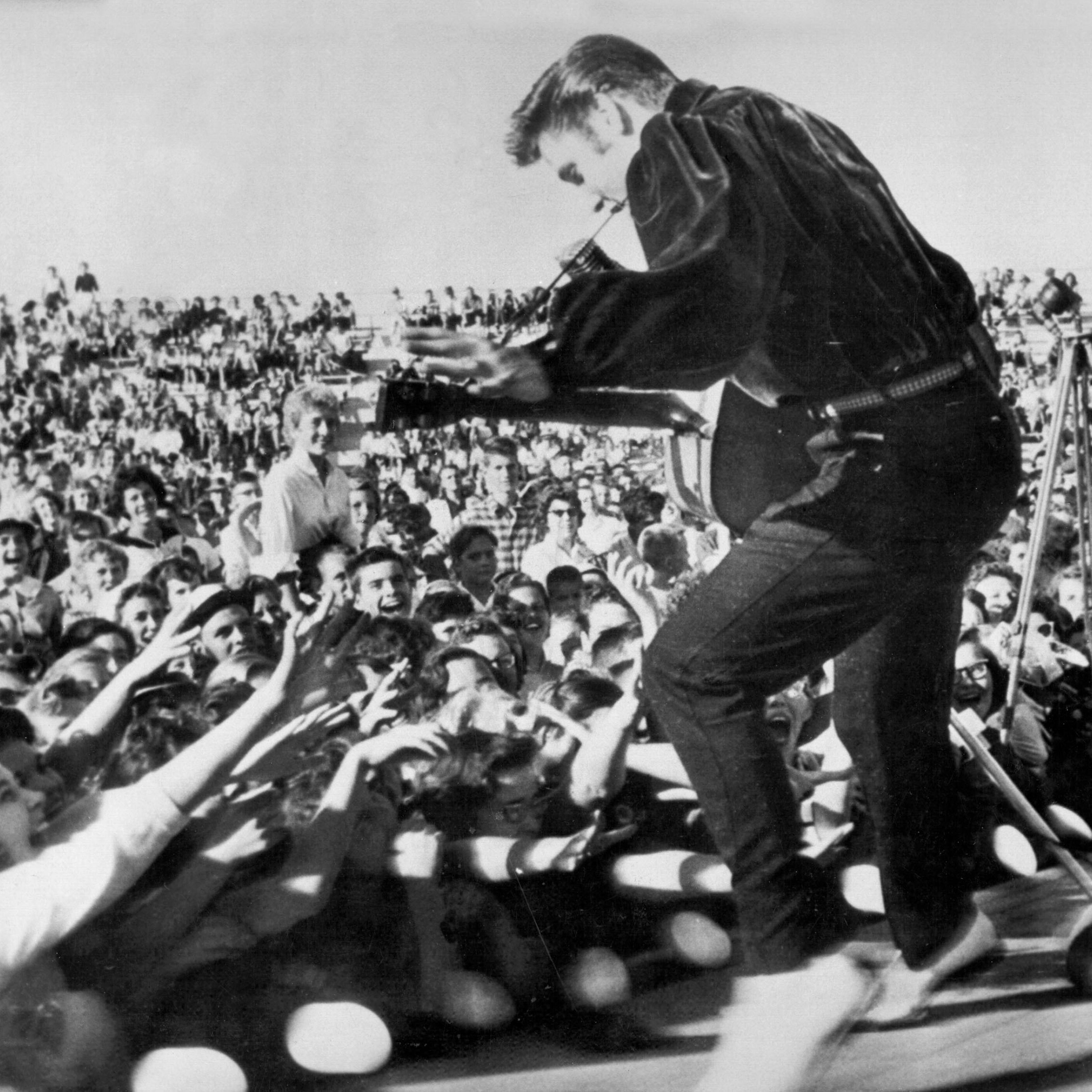 Elvis performs outside to adoring fans on September 26, 1956 in his hometown of Tupelo, Mississippi.