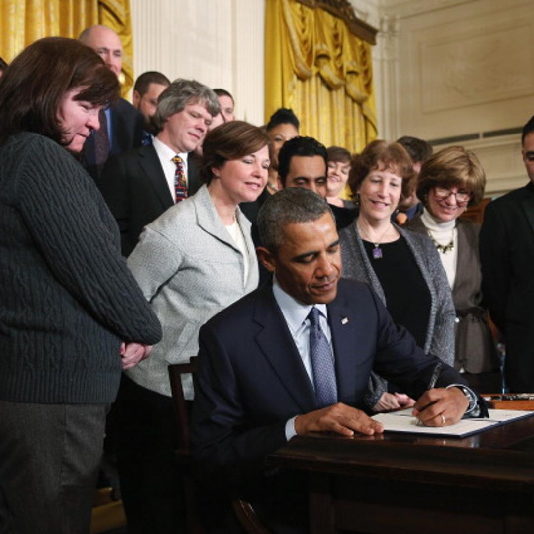 U.S. President Barack Obama signs a presidential memorandum for overtime protections for workers during an event in the East Room at the White House, on March 13, 2014 in Washington, D.C.