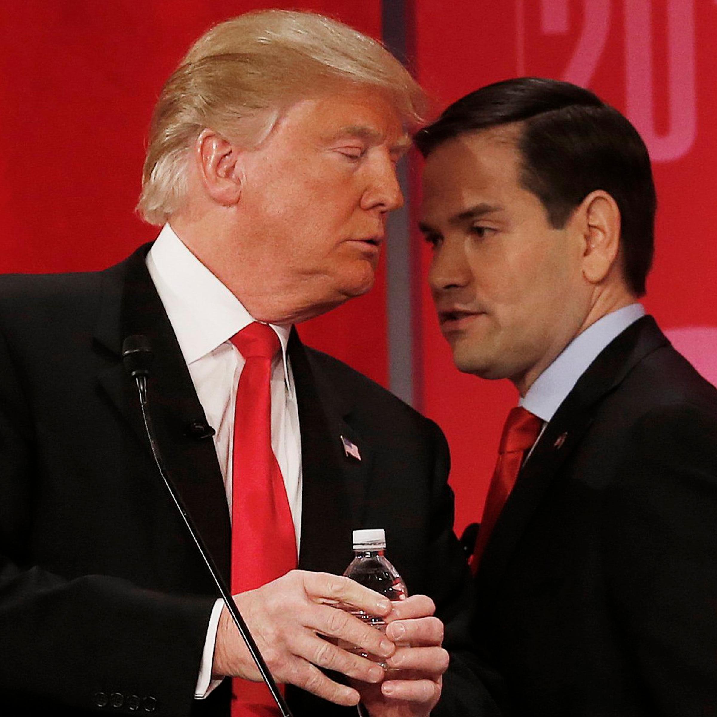 Republican presidential candidate, Sen. Marco Rubio, right, speaks to Republican presidential candidate Donald Trump during the CBS News Republican presidential debate at the Peace Center in Greenville, S.C., Feb. 13, 2016.