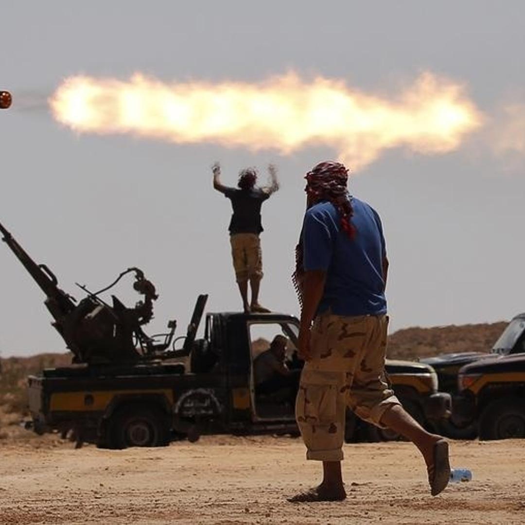 Anti-Gaddafi fighters fire a multiple rocket launcher near Sirte