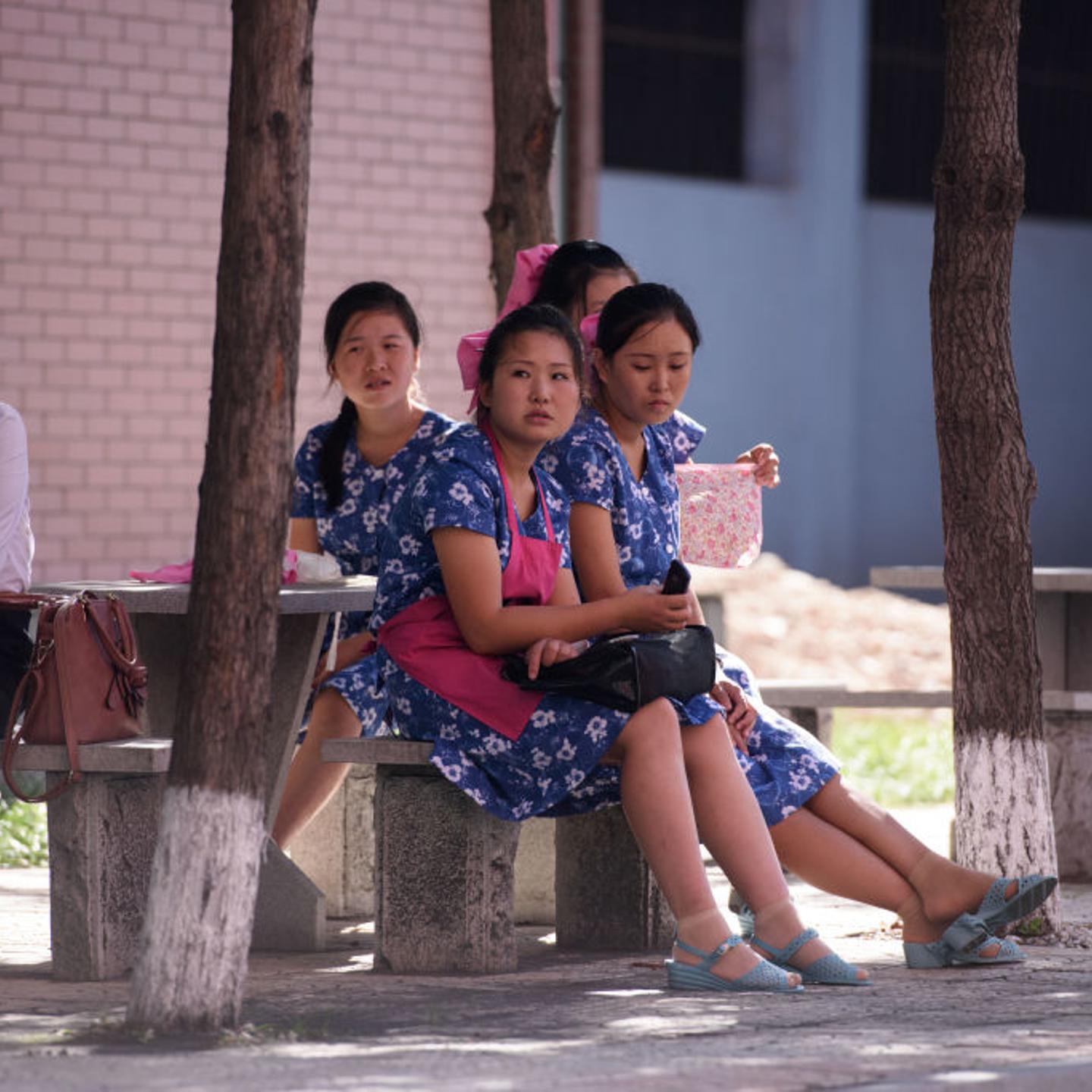 Workers rest outside the Kim Jong Suk textile factory during a guided tour for visiting foreign media, in Pyongyang on Sept. 7, 2018.