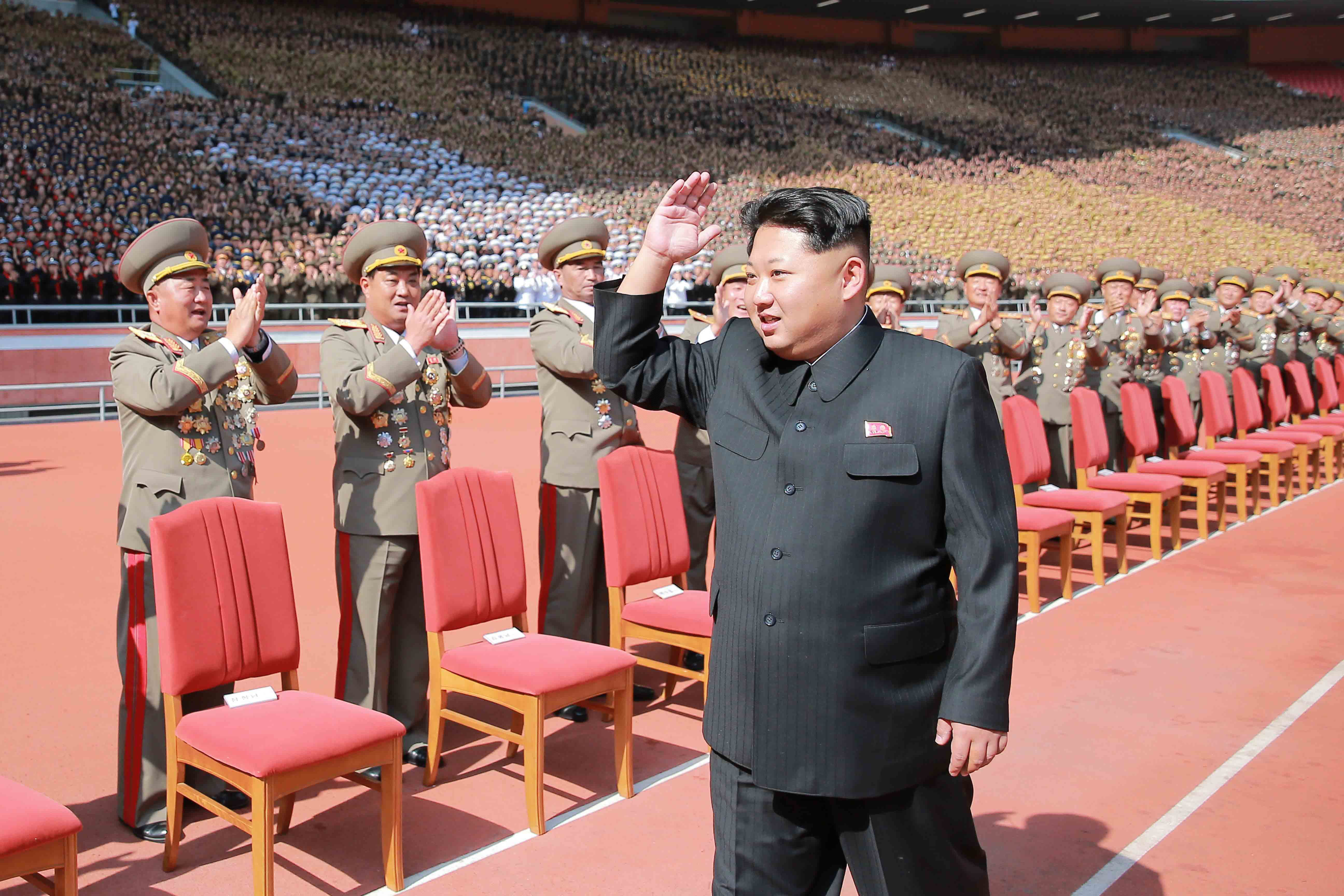 PYONGYANG, Oct. 14, 2015 -- Photo provided by Korean Central News Agency on Oct. 14, 2015 shows top leader of the Democratic People's Republic of Korea Kim Jong Un recently having a photo session with the participants in the military parade celebrating t