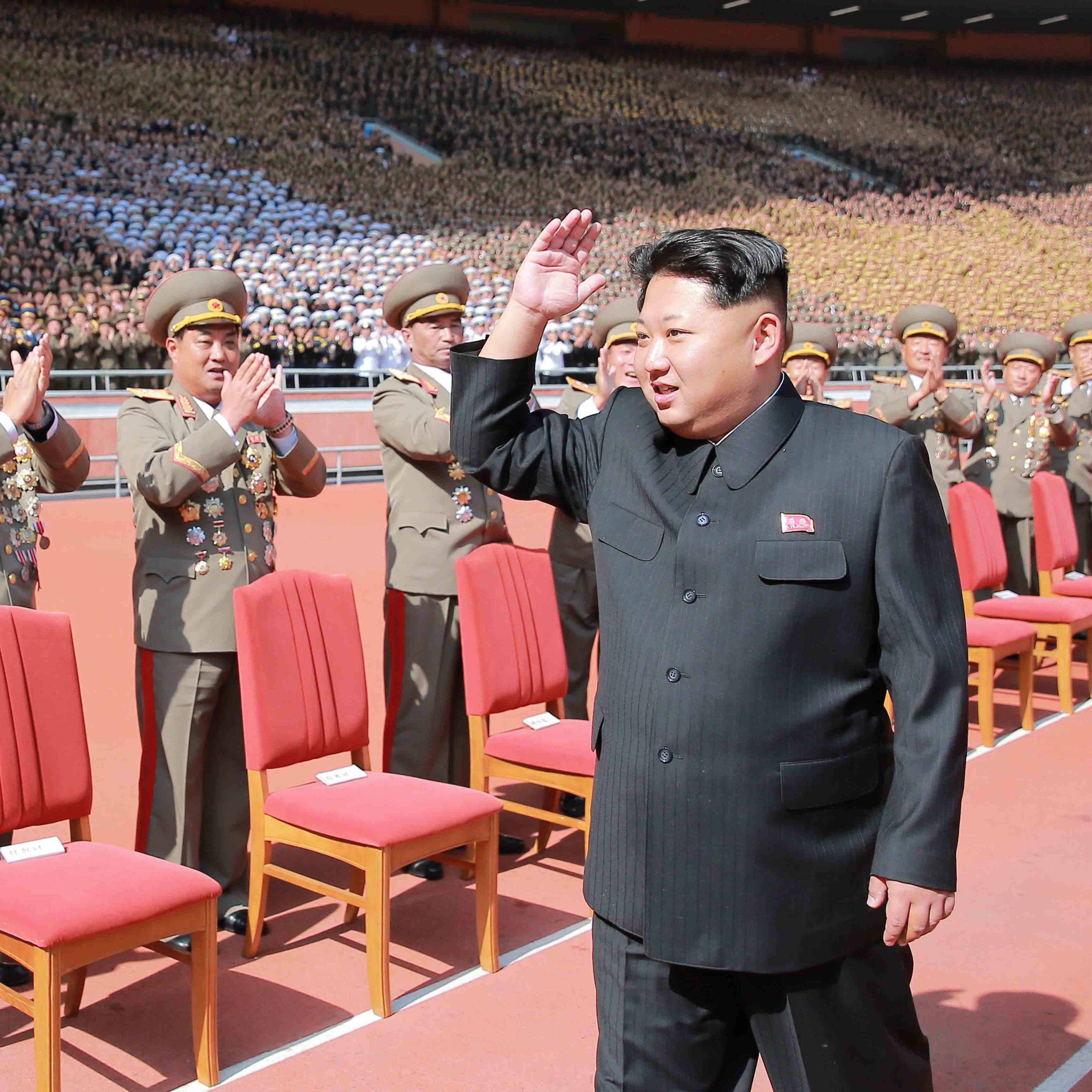 PYONGYANG, Oct. 14, 2015 -- Photo provided by Korean Central News Agency on Oct. 14, 2015 shows top leader of the Democratic People's Republic of Korea Kim Jong Un recently having a photo session with the participants in the military parade celebrating t